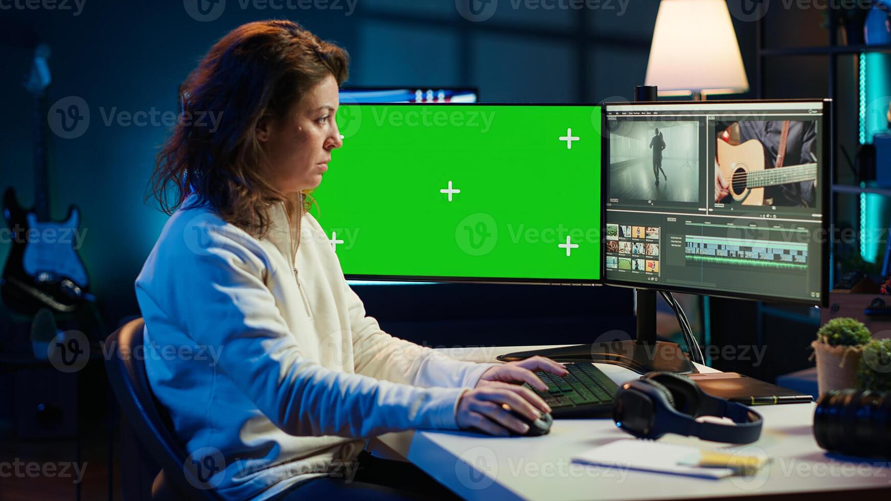 editor using editing software on green screen monitor to upgrade footage shot, commissioned by production teams outsourcing tasks. Freelancer videographer finishes project on mockup PC, camera A photo