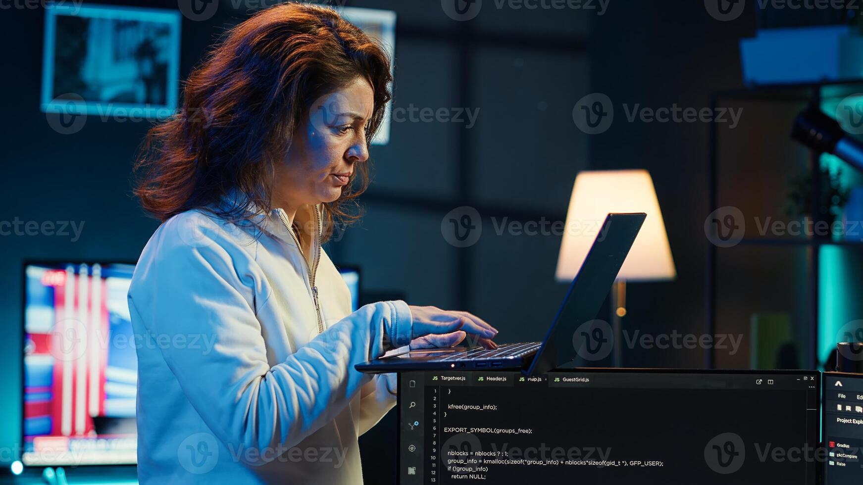 Developer doing software debugging using laptop, checking glitches in lines of code, upset about errors. Woman walking around home fixing coding issues using notebook device, camera A photo