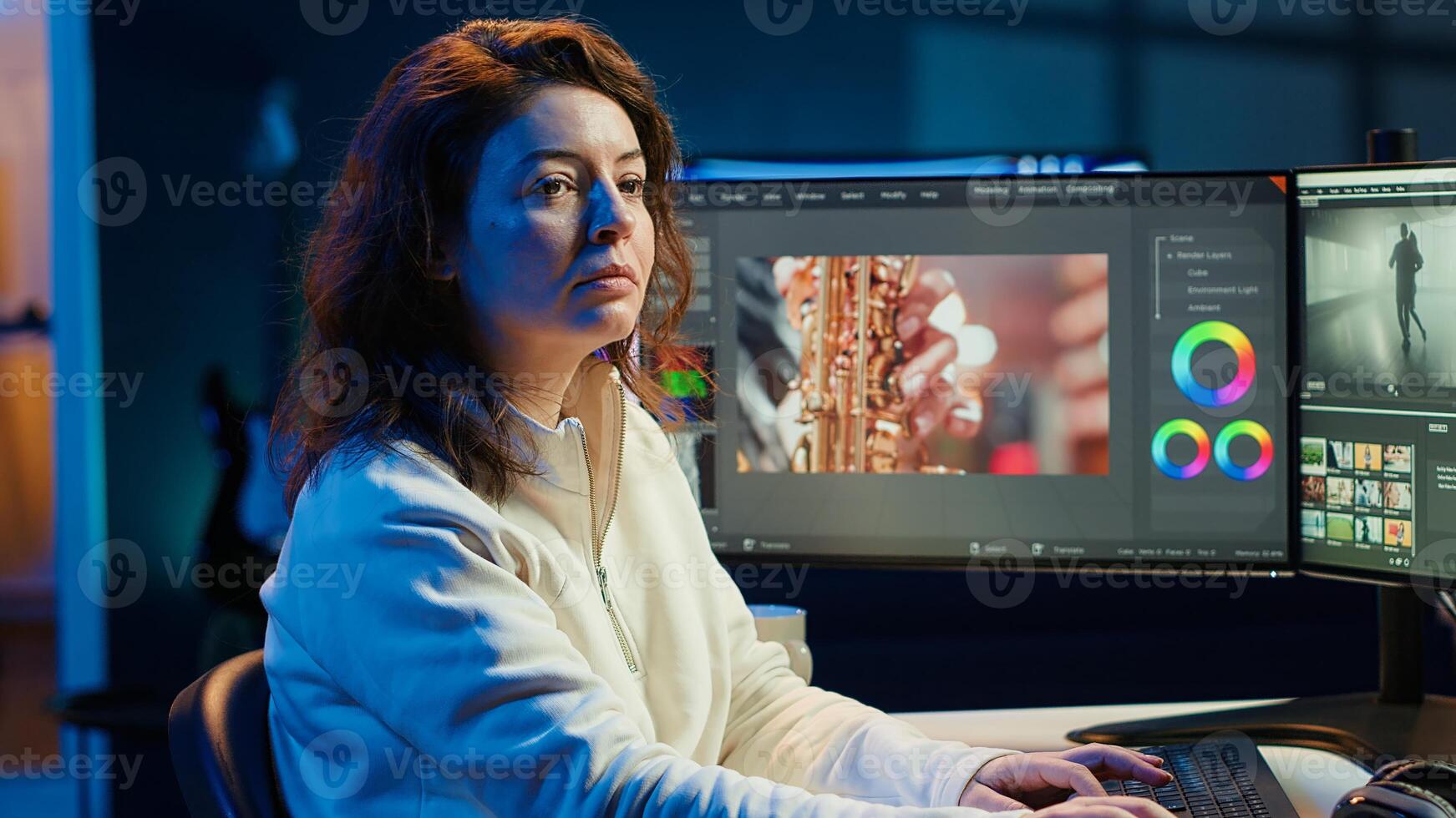 Upbeat videographer reviewing footage and selecting scenes, trimming using specialized software applications and editing tools. Smiling editor working for media company in editing room, camera A photo