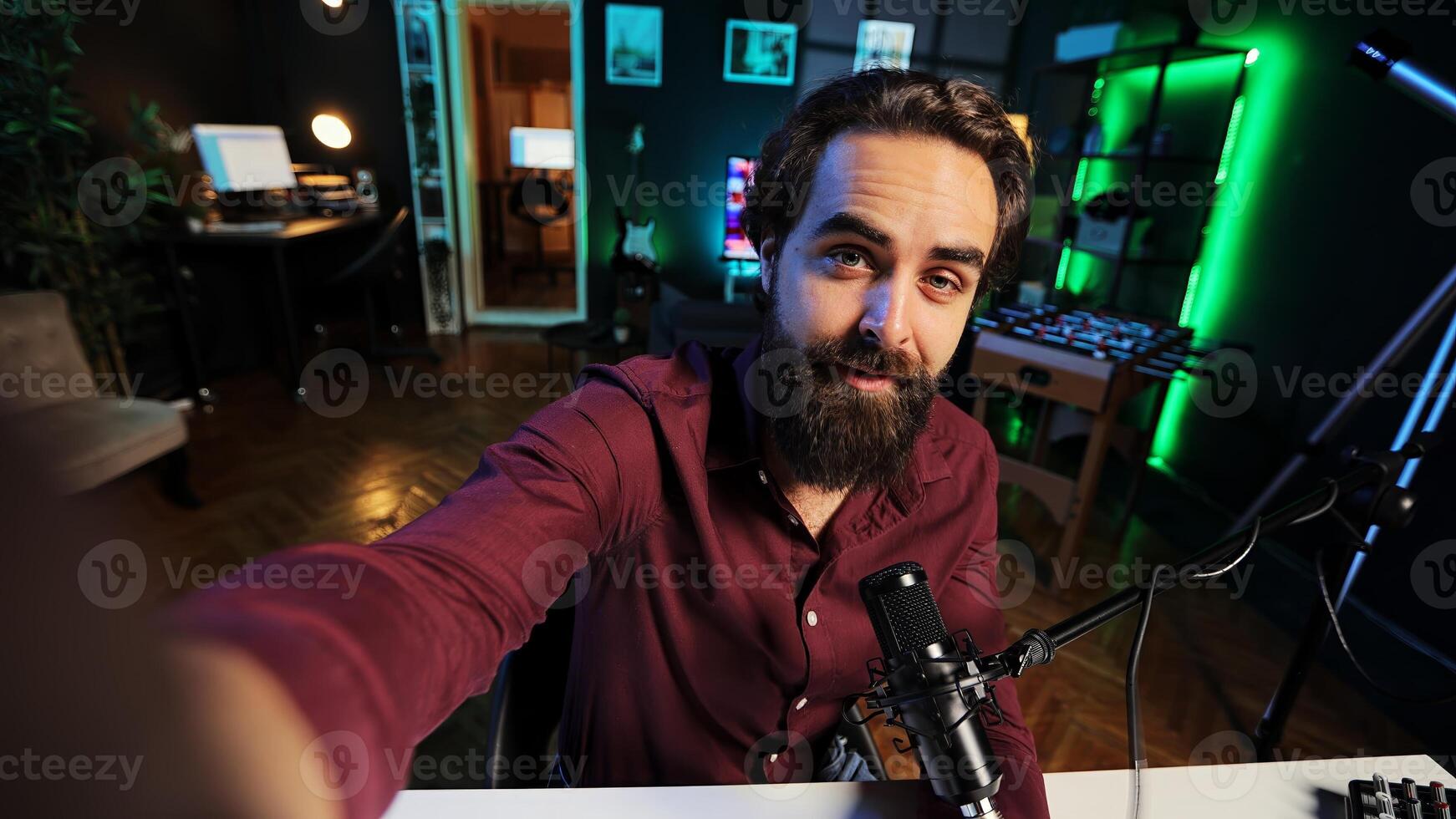 Content creator using professional recording equipment to film vlog channel intro, talking with subscribers. POV shot of man recording himself greeting fans, covering different subjects photo