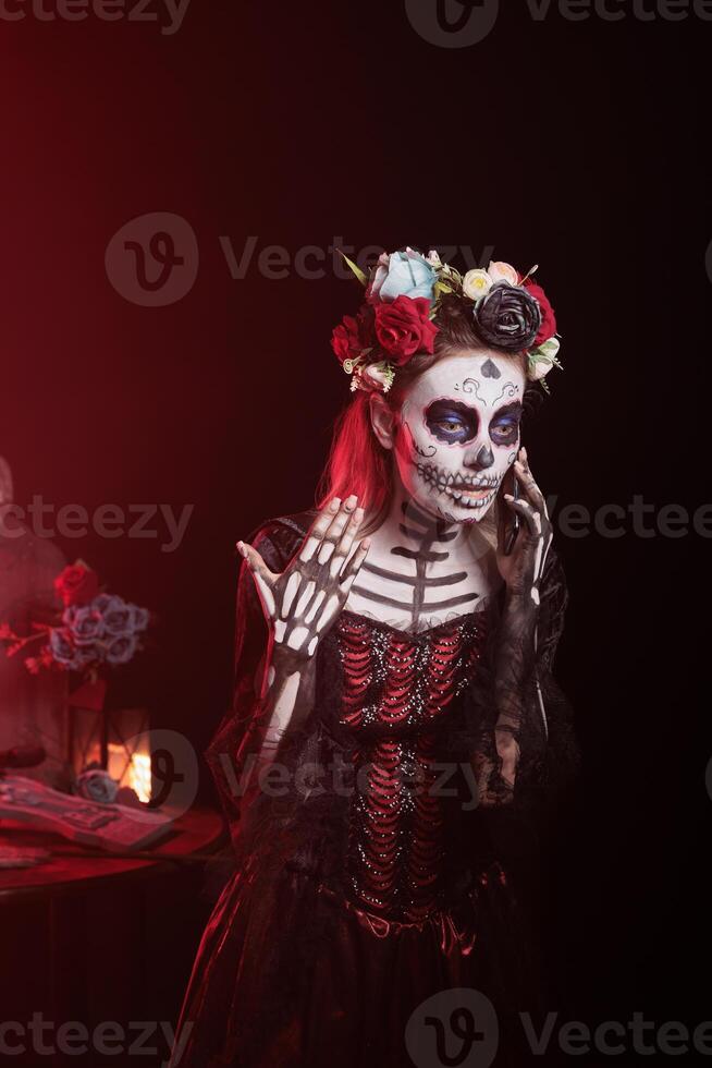 Woman arguing with friends in telephone call during Day of the Dead celebration honoring dead loved ones. Person having fight with mates in call during ancient Aztec custom of celebrating ancestors photo
