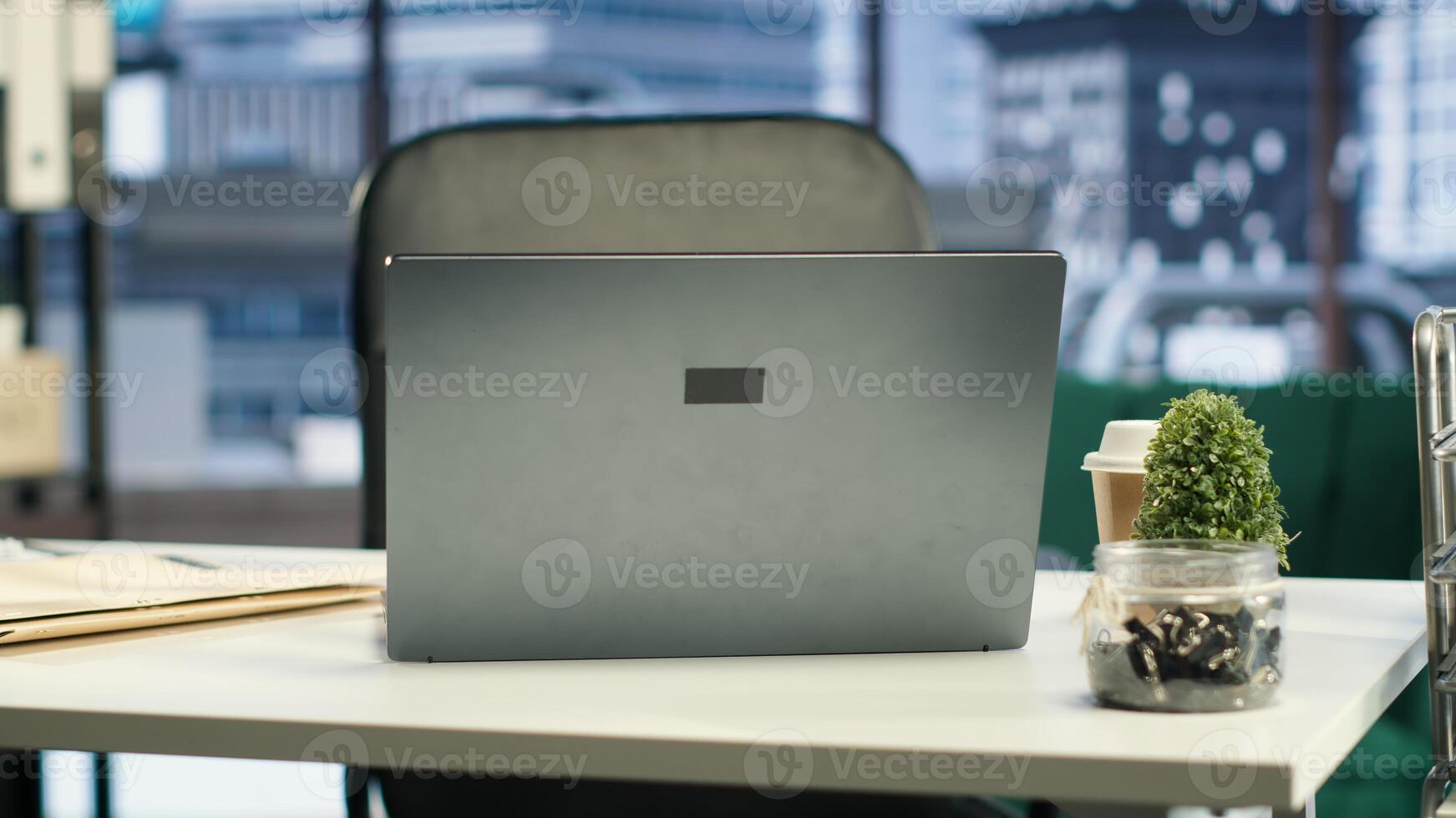 Empty urban corporate high end office designed for a person with authority, analytics and profit trends running on screen. Modern global enterprise workspace, business success. photo