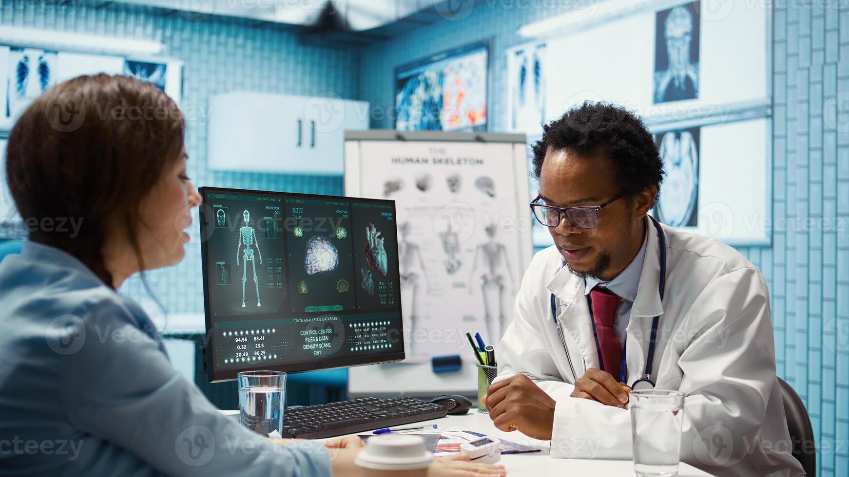 Medical expert taking oxygen saturation levels with an oximeter, doing measurements and vital signs readings with a digital device with clip. Doctor consulting a patient at appointment. Camera B. photo