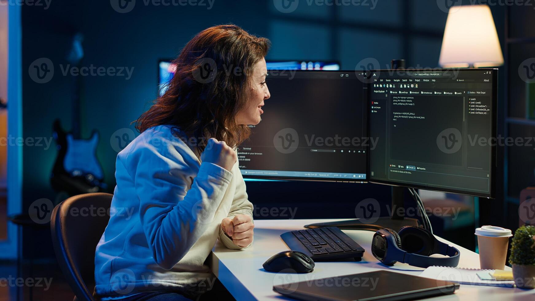 Happy developer celebrating after managing to secure company servers from virus attacks. Cheerful IT employee throwing fist in air from excitement after building firewalls protecting data, camera A photo