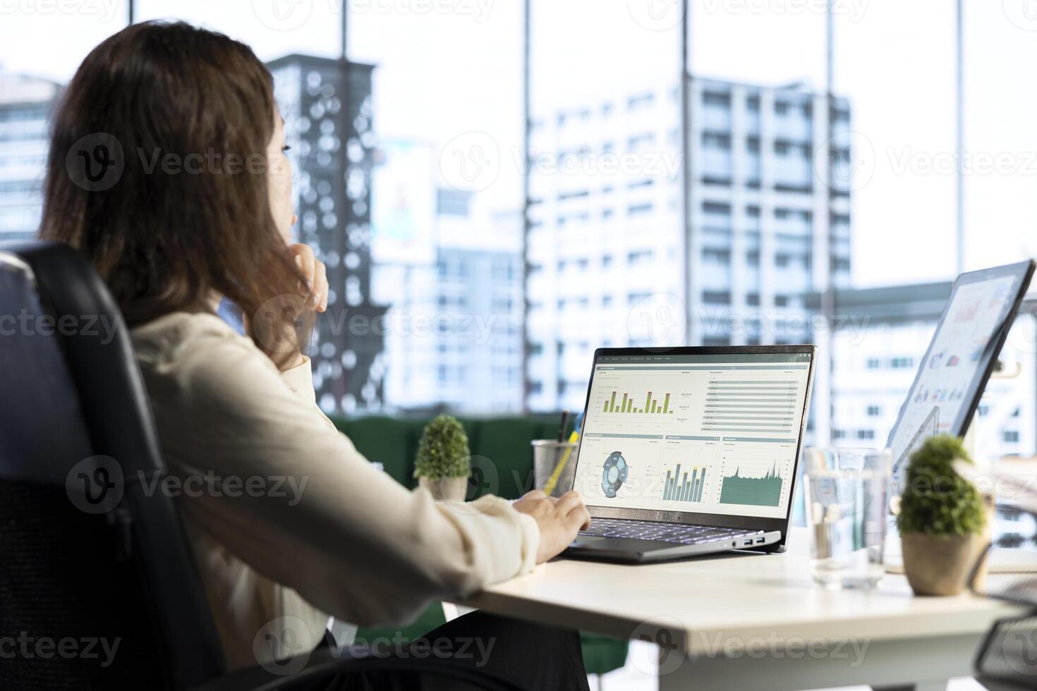 Ambitious woman executive ensuring corporate innovation, exploring new technologies and business models to enhance the company competitive advantage. Evaluating results and analytics. photo