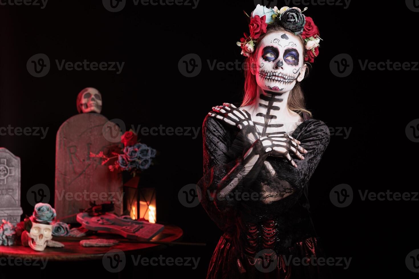 Portrait of mysterious girl at Halloween Dia de los Muertes indigenous rites of honoring the dead. Woman wears elegant silk dress participating in Day of the Dead celebration in honor of the deceased photo
