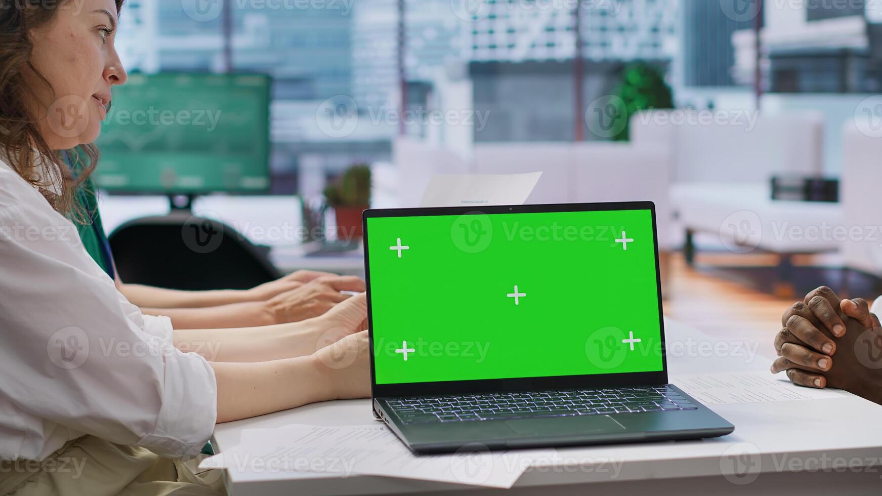 Job seeker attending an interview with the HR team next to mockup screen on laptop, recruiters reviewing qualifications and work experience written in the resume. Employment. Camera A. photo