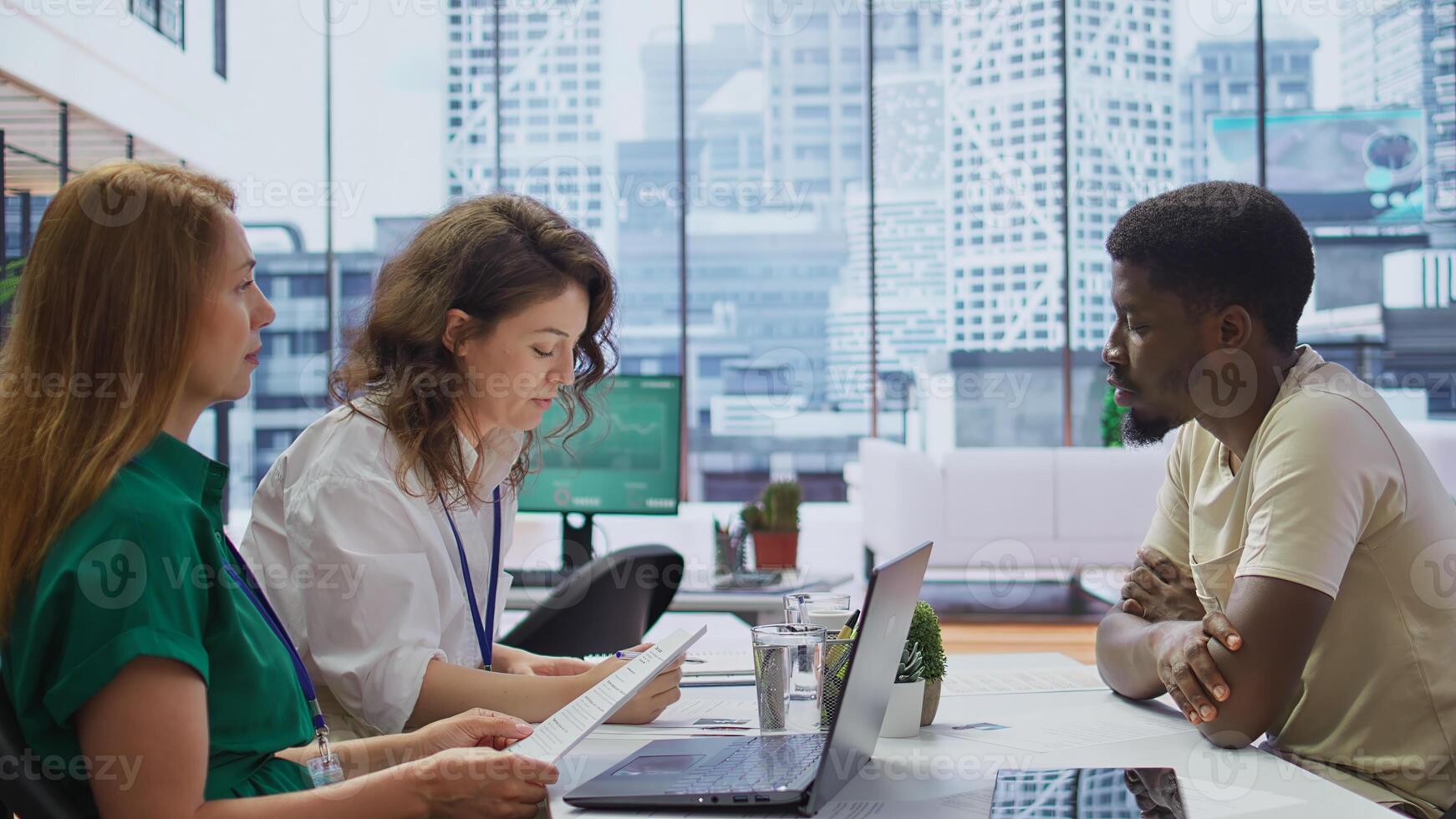 HR manager conducting a detailed interview with a potential candidate in a modern office, discussing qualifications, previous experience and career goals. Headhunter studies CV. Camera B. photo