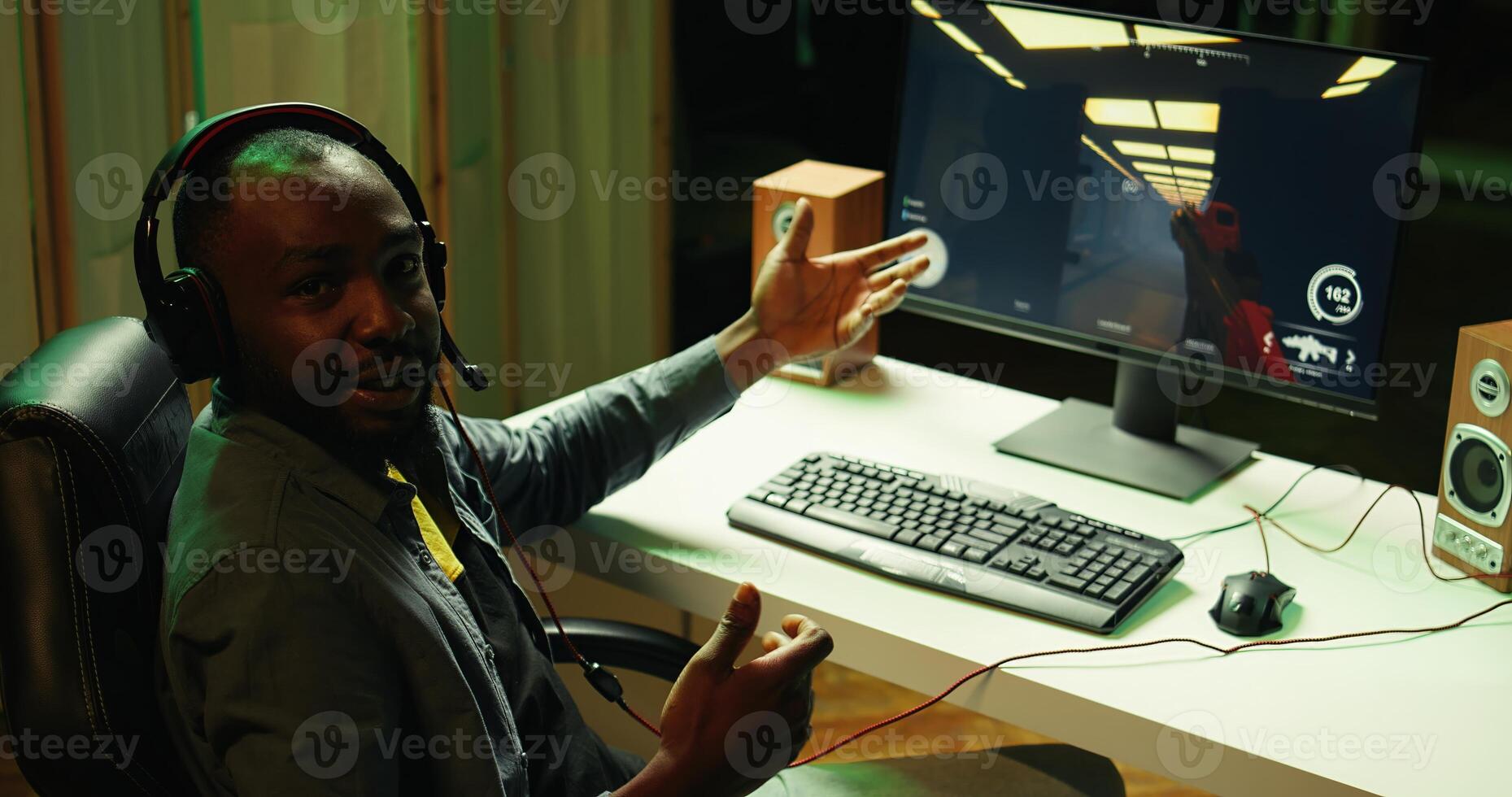 Pro gamer wearing headphones playing game, teaching audience esports needed skills. Content creator in gaming chair talking with audience, filming tutorial on how to defeat enemies, camera B photo
