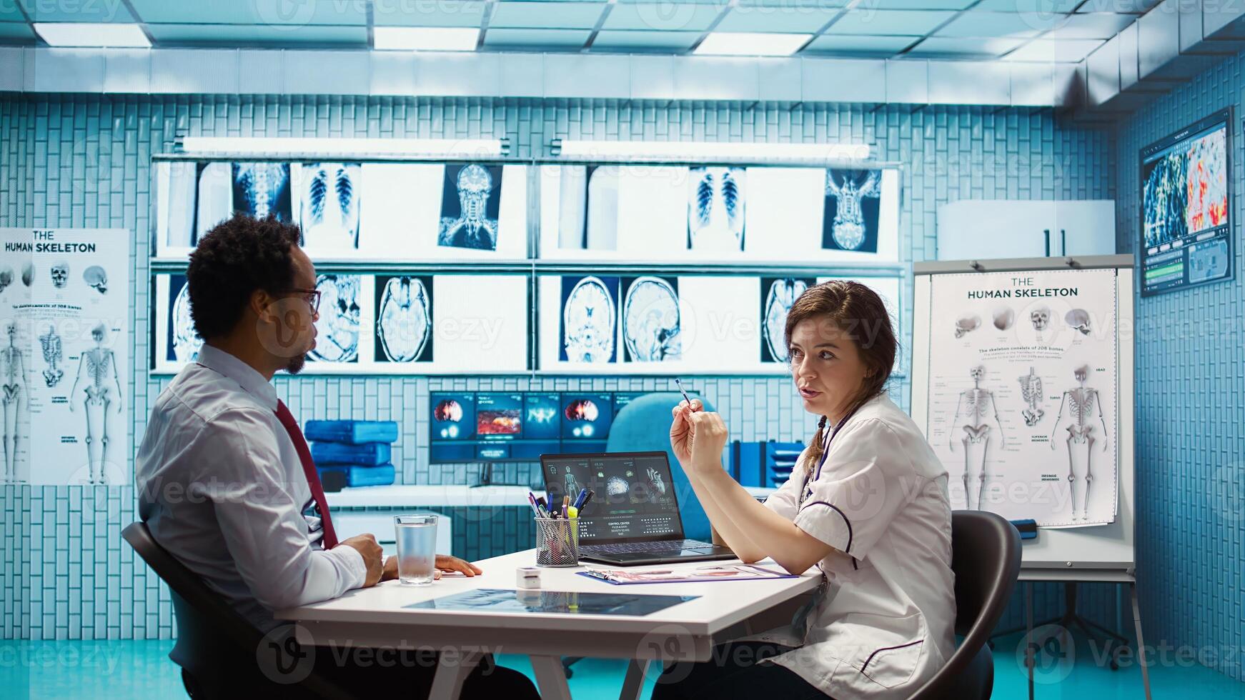 Healthcare professional sharing her medical expertise with a patient in office, reviewing x ray and MRI scans and focusing on accurate diagnostics and patient care. Diagnostic report. Camera B. photo