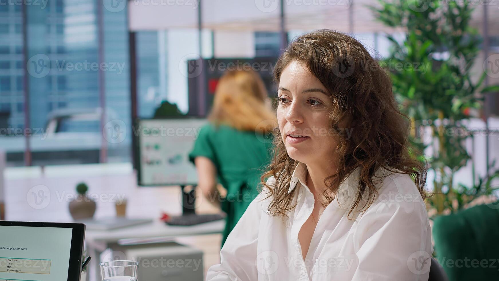 Recruiter interviewing job applicant to learn about her qualifications and skill, explaining possible career and human resources development plans. Recruitment process for hiring. Camera A. photo