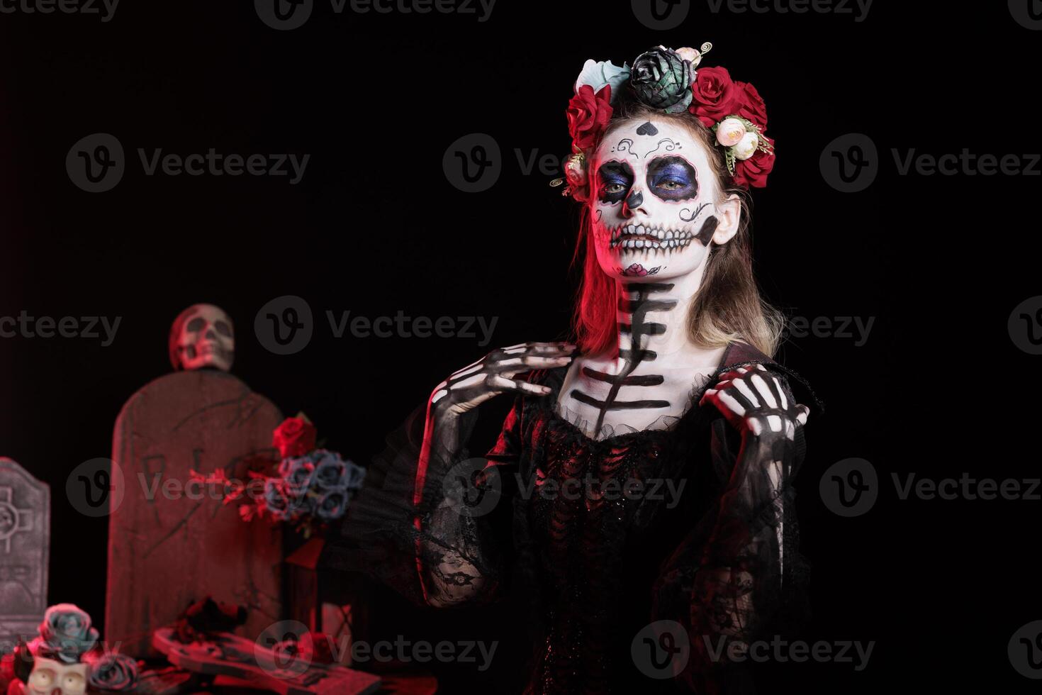 Portrait of person wearing skeleton makeup and horror outfit to celebrate dios de los muertos during Halloween. Scary lady dressed as La Catrina character on day of the dead holiday photo