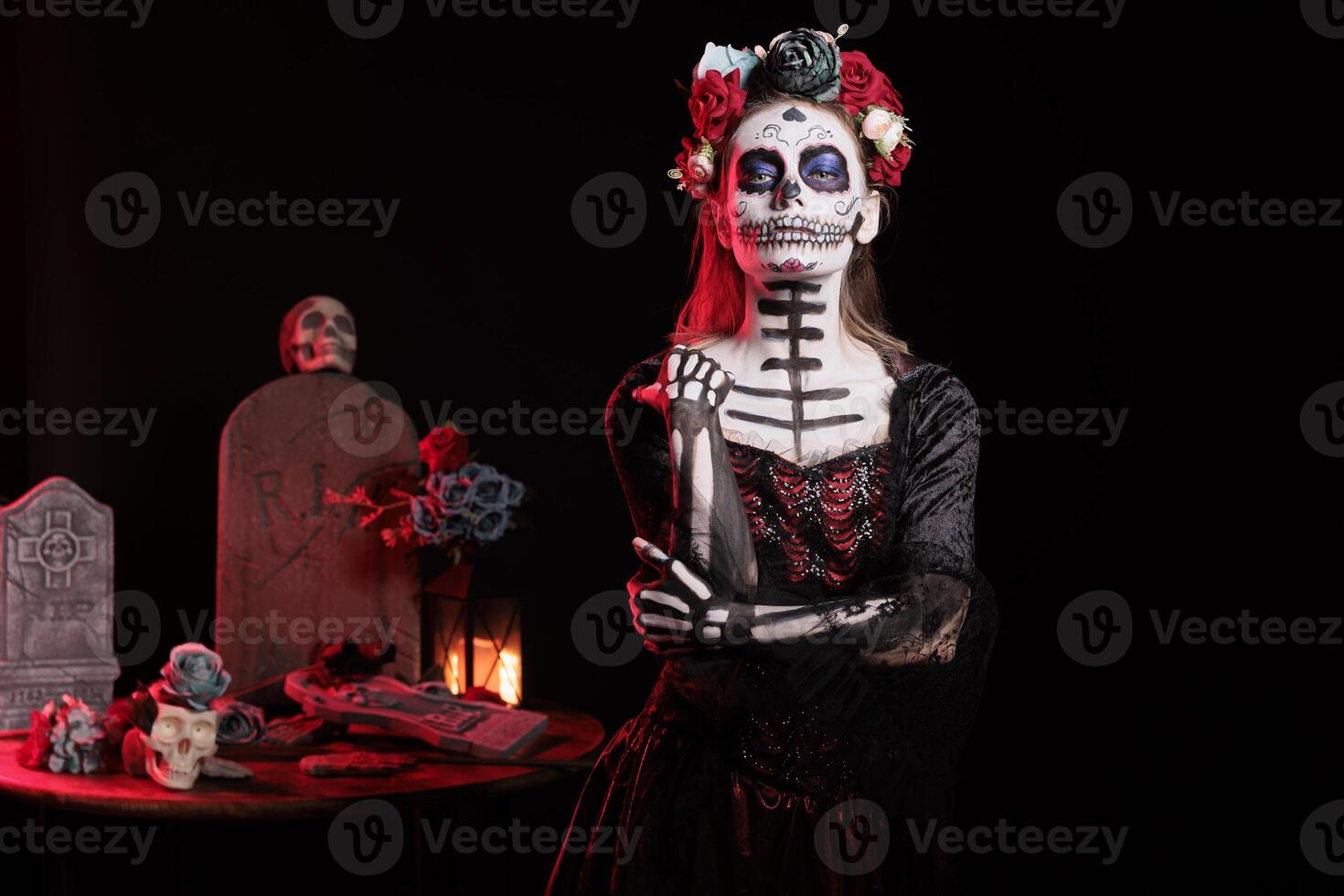 Woman dressed in dark costume during Day of the Dead Mexican event honoring dead loved ones. Creepy lady with corpse body paint during ancient Aztec custom of celebrating ancestors photo