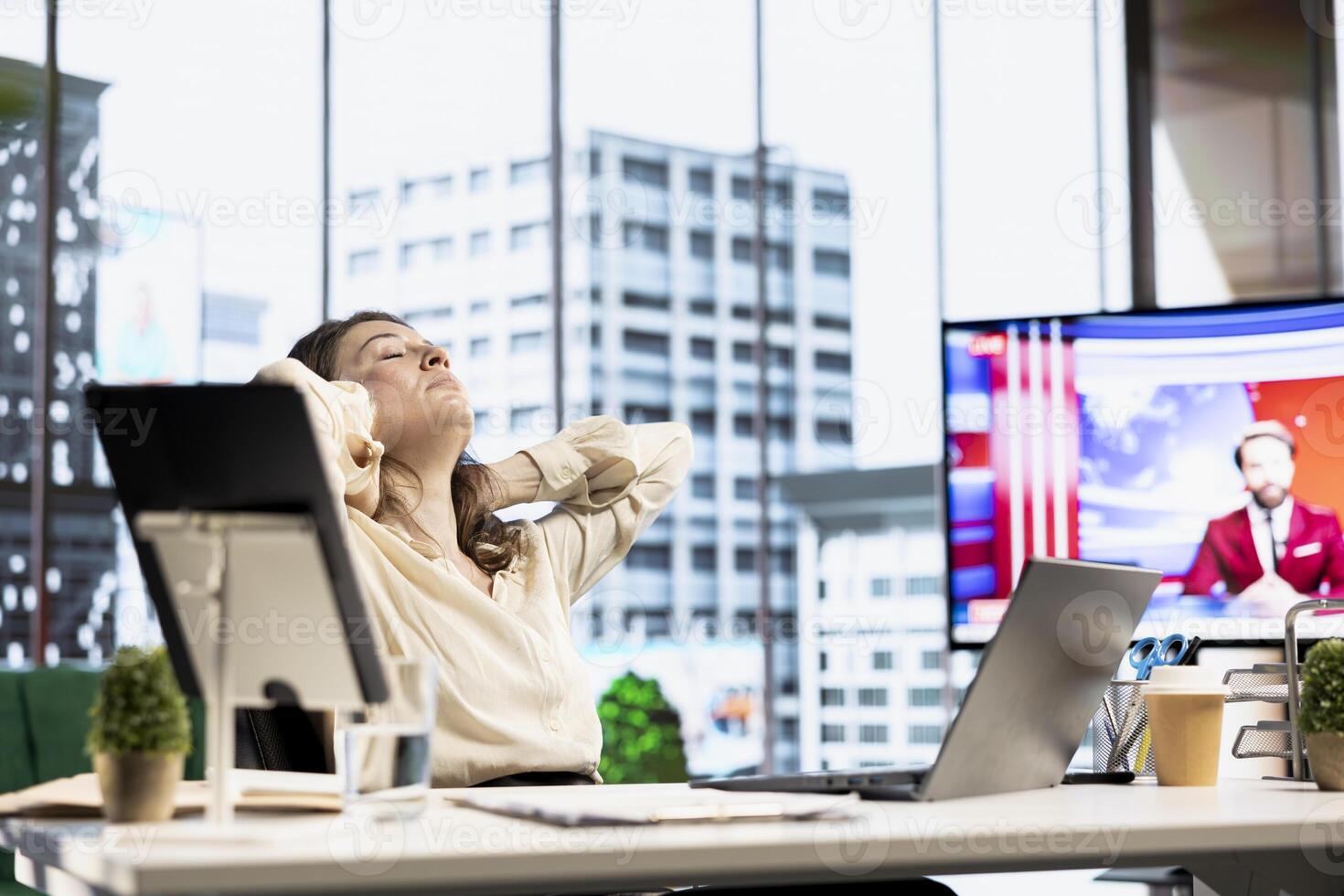 Woman CEO dealing with muscle cramps due to incorrect posture at the desk, having neck and back ache while she works in her office. Female director with spasm and sedentary life. photo