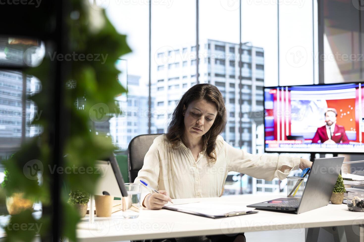 Female entrepreneur working on her legal obligations to sign paperwork and work contracts, approving all documents for performance and productivity. Businesswoman CEO gives authorizations. photo