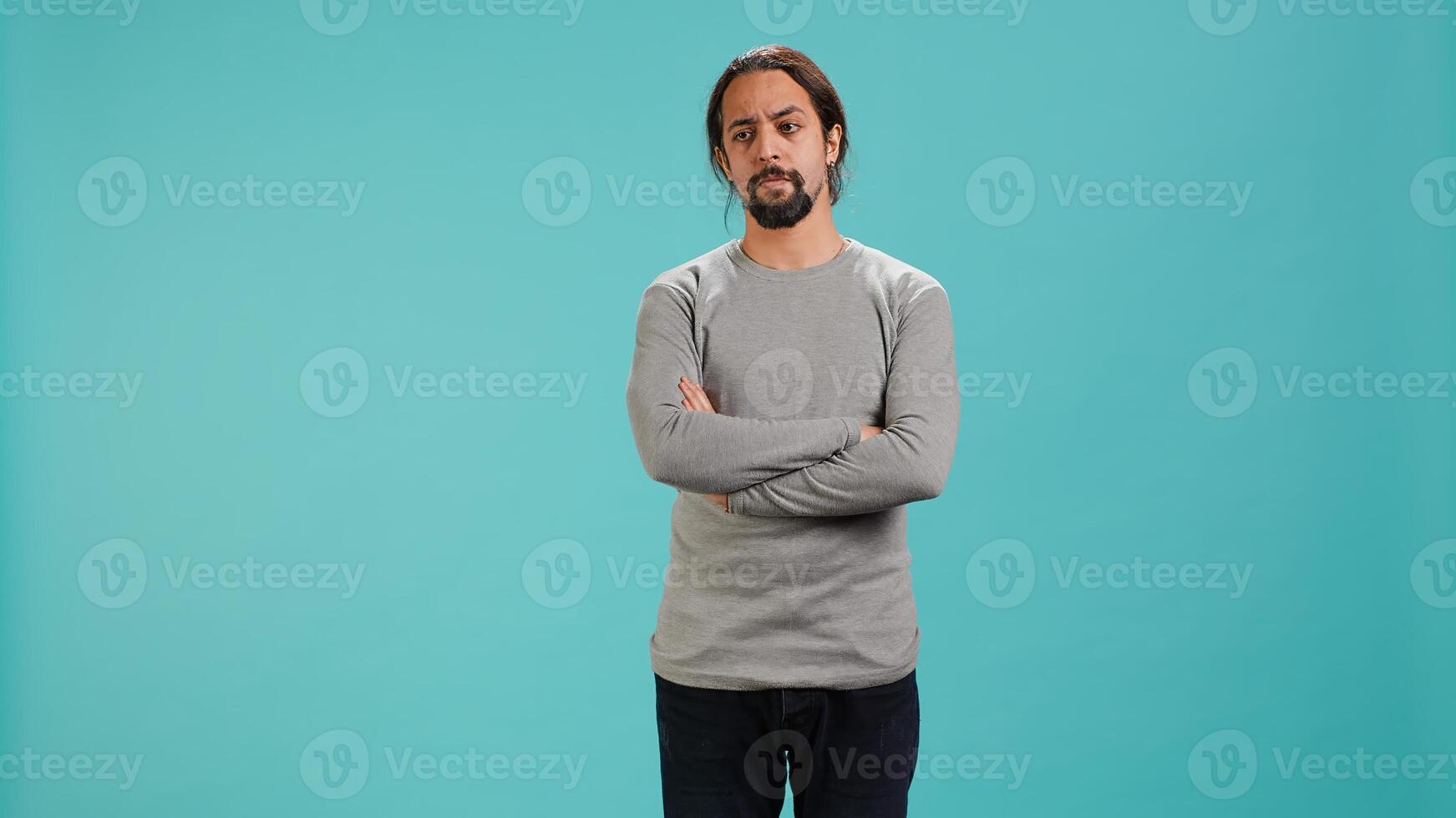 Grumpy man crossing arms, feeling upset by events, isolated over studio background. Portrait of stressed moody person shaking head, left speechless by troubling news, camera A photo