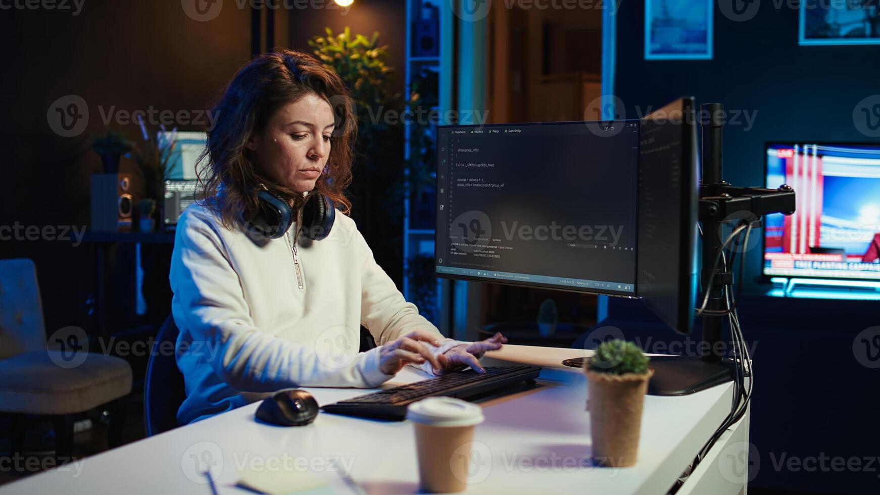 Programmer teleworking from own apartment filtering malicious traffic from cybercriminals attempting to corrupt company data using computer, preventing phishing attacks, camera B panning shot photo