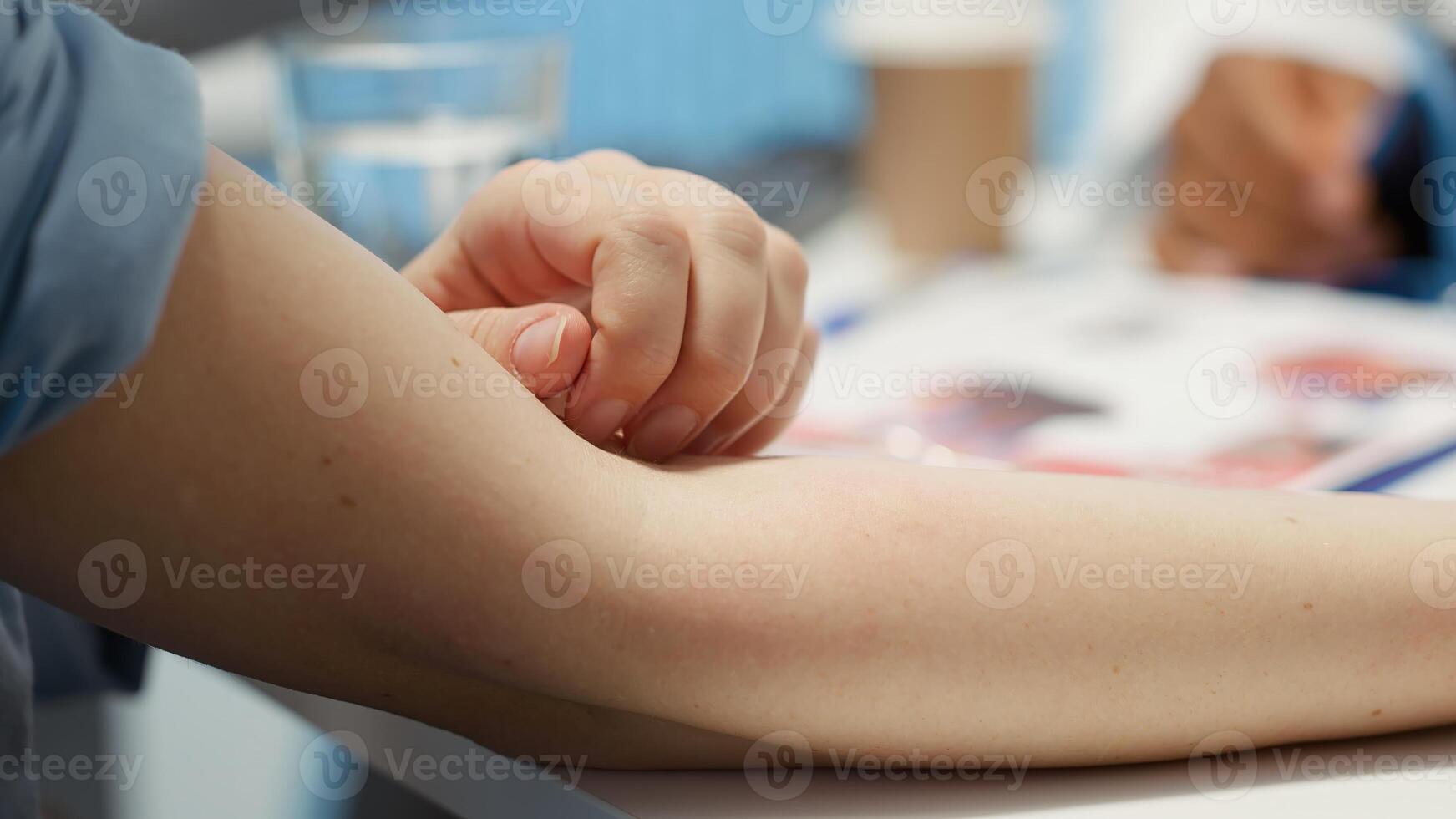 Nervous female patient with an itchy sensation feels afraid and anxious at check up visit, having a rash on her skin. Woman meeting with specialist for a medical consultation. Close up. Camera A. photo