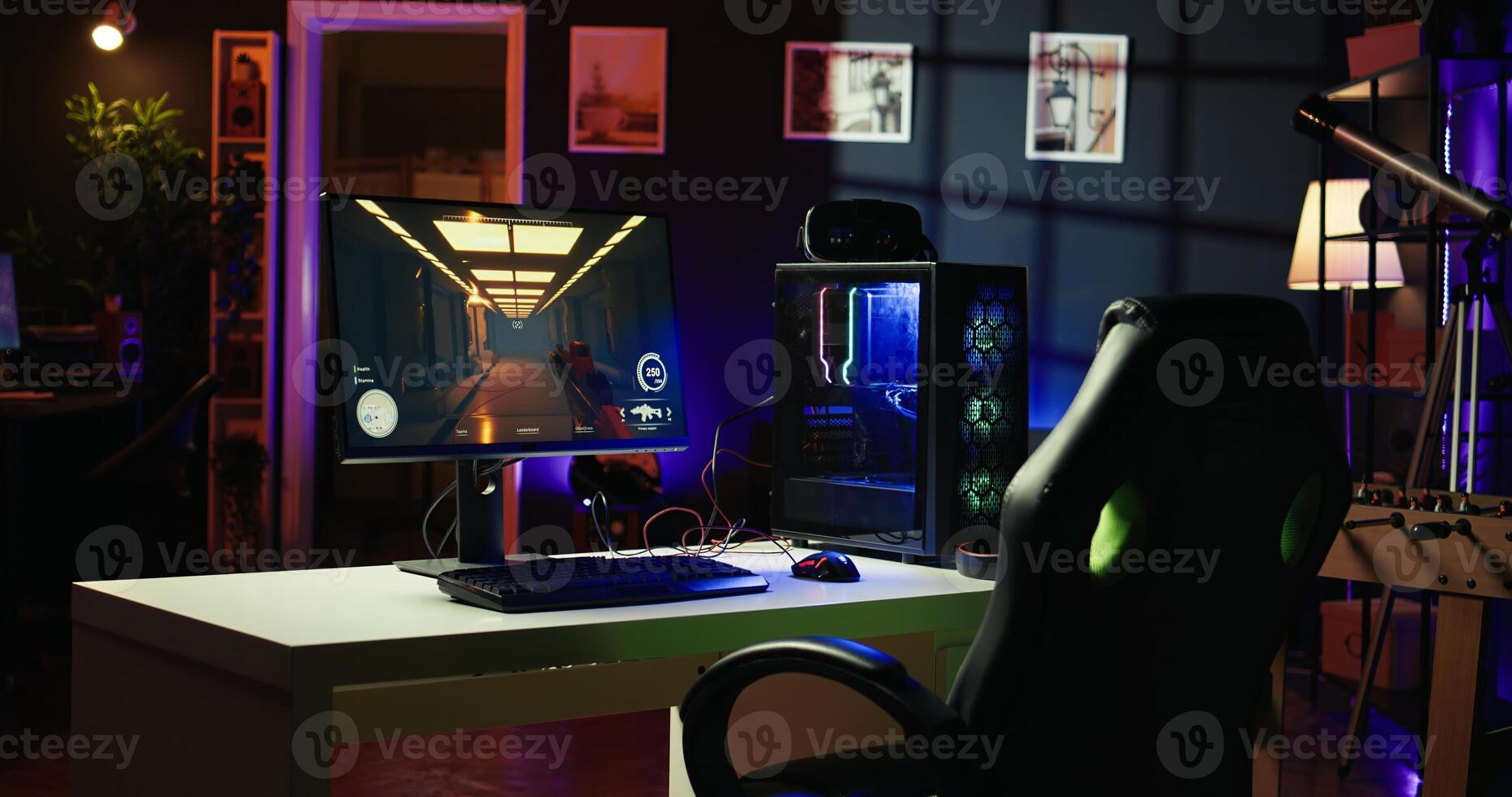 Computer screen showing FPS videogame left open at night in empty apartment with RGB lights. Close up shot of PC, keyboard and mouse on desk in living room with no people in photo