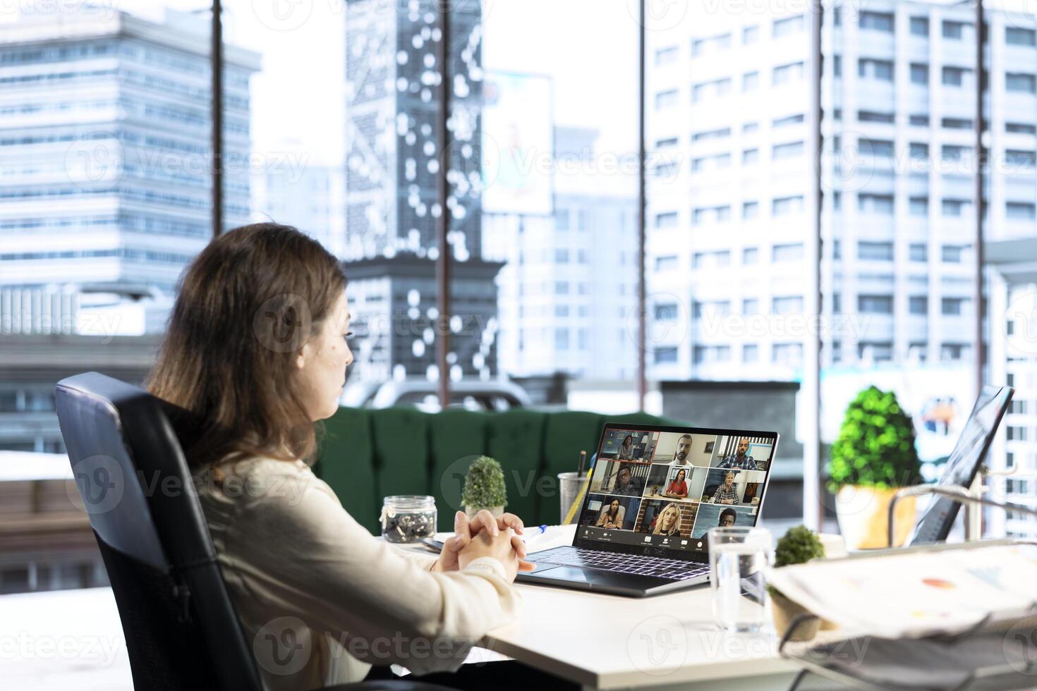 Ambitious influential businesswoman mentors young professionals on teleconference, sharing her experiences, leadership insights and advice on achieving career success and personal growth. photo