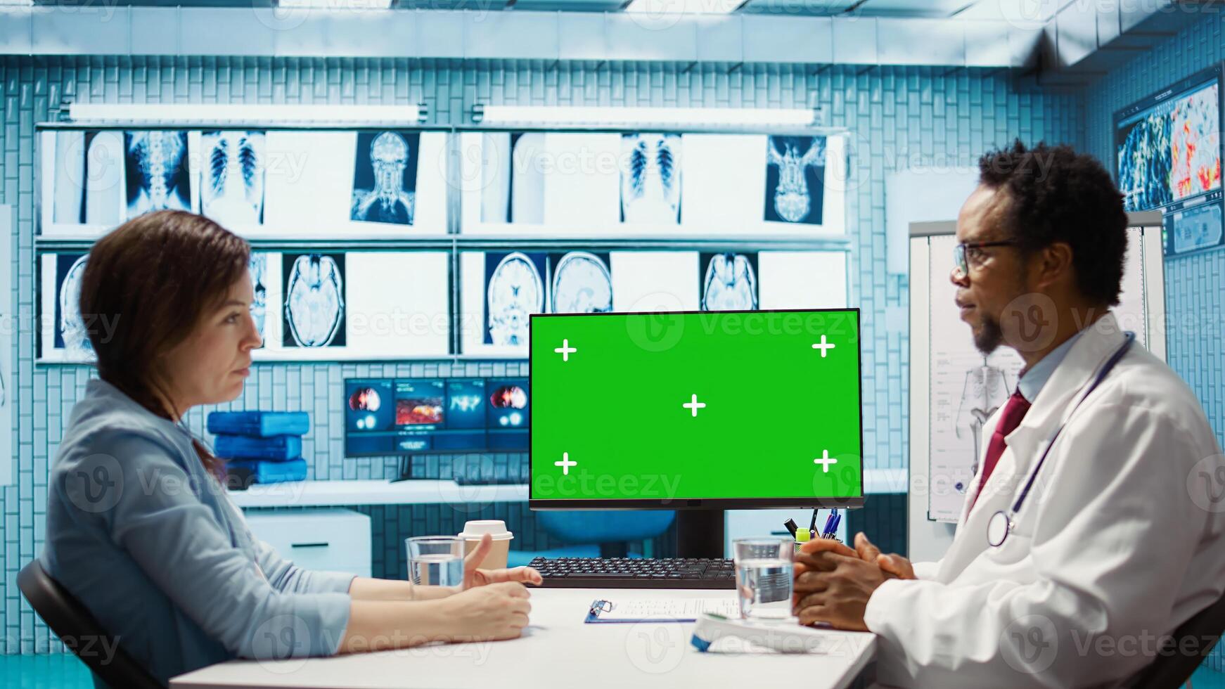 Male physician expert presenting diagnosis on isolated chroma key screen, discussing lab test results with a female patient in cabinet. Doctor working in healthcare industry. Camera B. photo