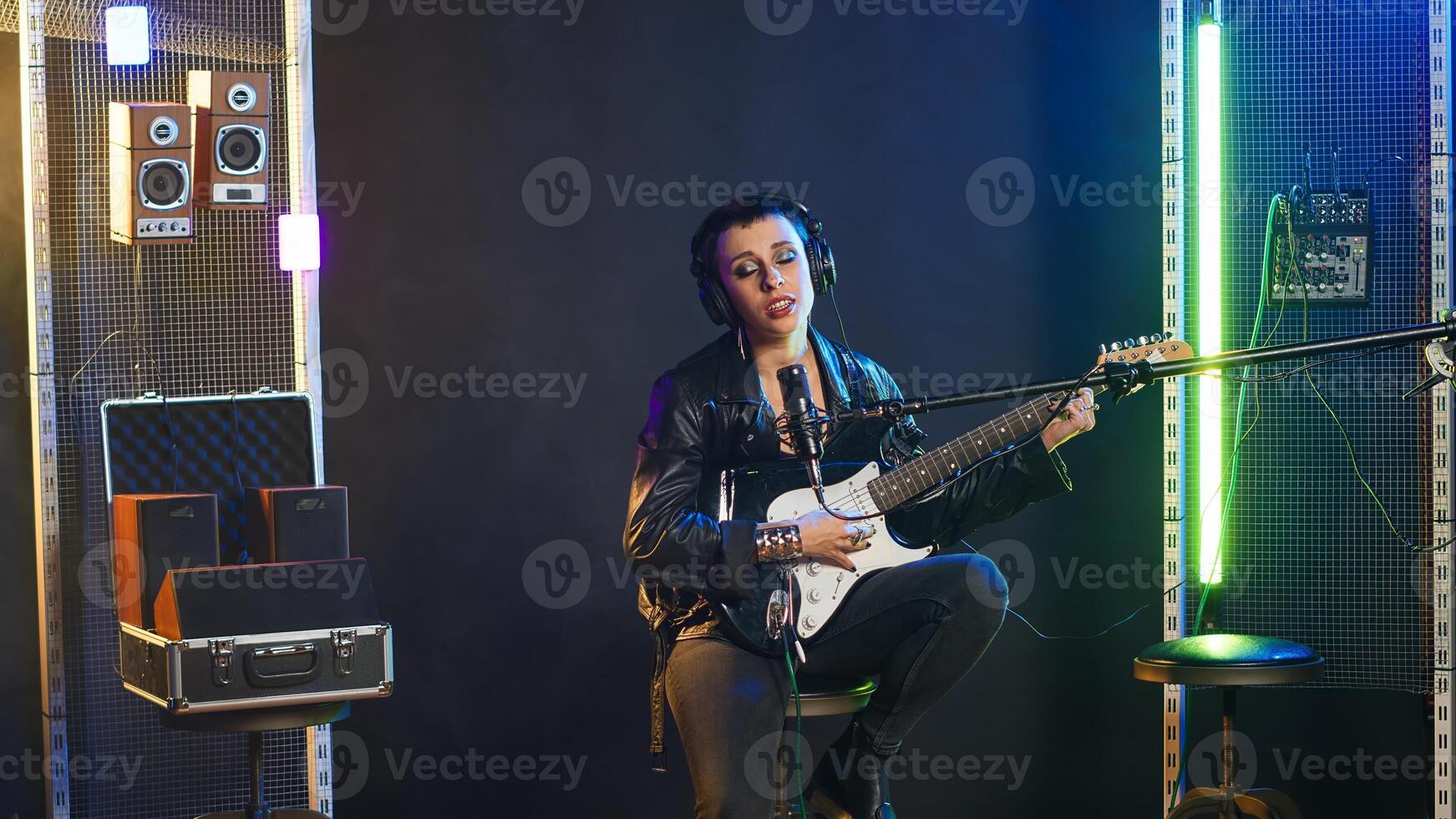 Confident female singer delivers a powerful vocal performance in a live show. Edgy heavy metal artist with rock star vibes performing a live song, iconic artist singing alternative music. Camera B. photo