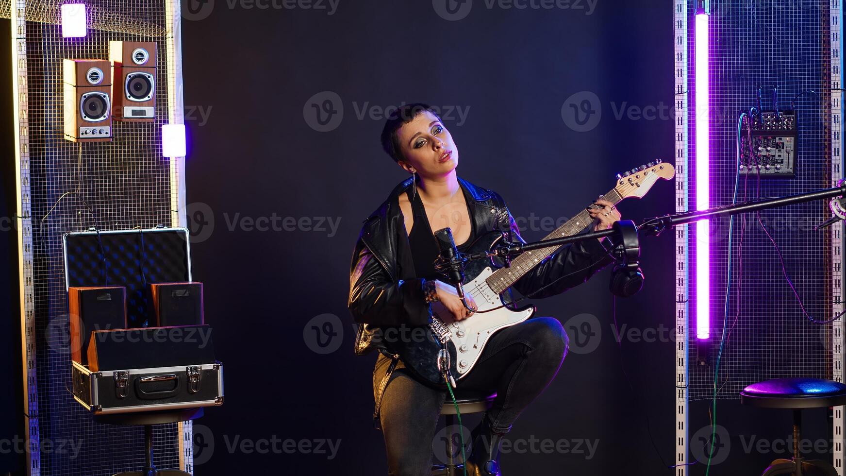 Confident female singer delivers a powerful vocal performance in a live show. Edgy heavy metal artist with rock star vibes performing a live song, iconic artist singing alternative music. Camera B. photo