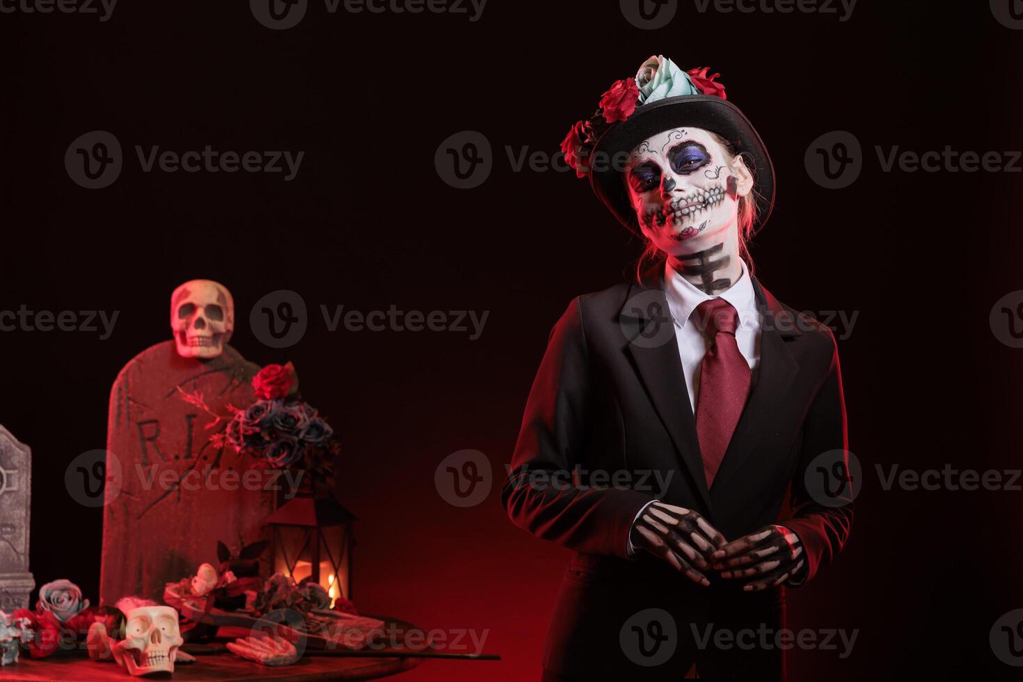 Portrait of happy woman wearing suit during Day of the Dead Halloween event honoring dead loved ones. Cheerful mystical lady doing ancient Aztec custom of celebrating ancestors photo