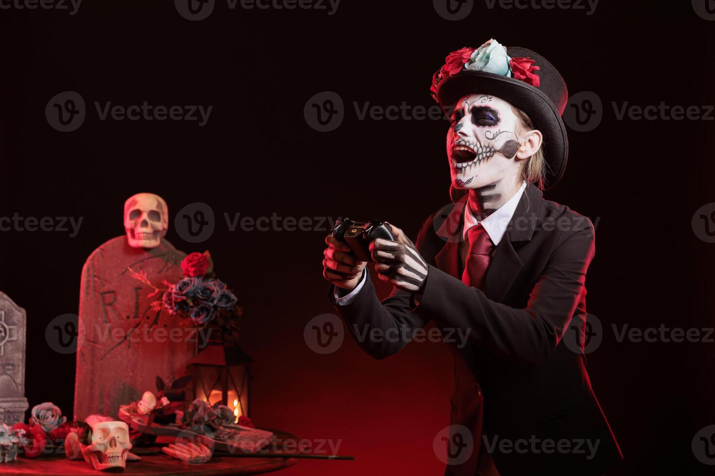 Lady gaming with gamepad at religious processions during Dia de los Muertos november holiday. Woman playing videogames with controller, wearing skeleton makeup symbolizing reverence for deceased photo