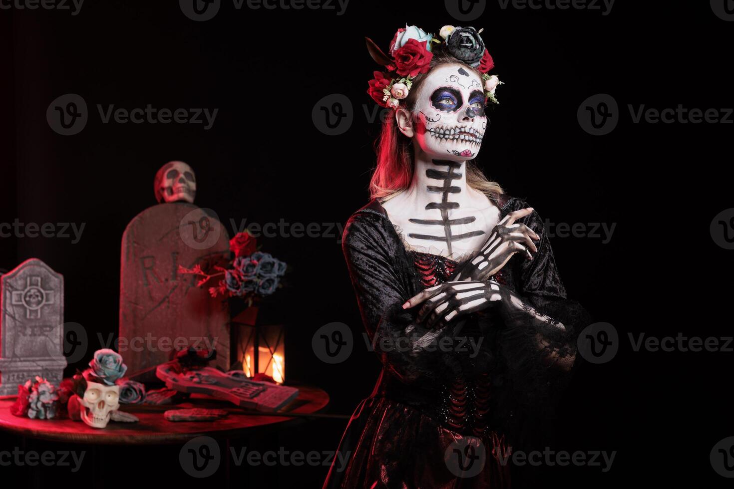 Woman with flower wreath on head at Day of the Dead event to remember the deceased, celebrating their memory. Lady wearing gothic corpse makeup for holiday of remembrance for those who have passed photo