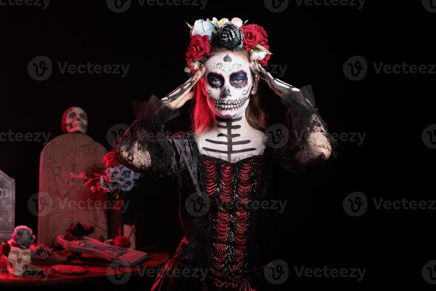Woman at Day of the Dead event to remember the deceased and celebrating their memory, graveyard background. Lady wearing skull makeup for mexican holiday of remembrance for those who have passed photo