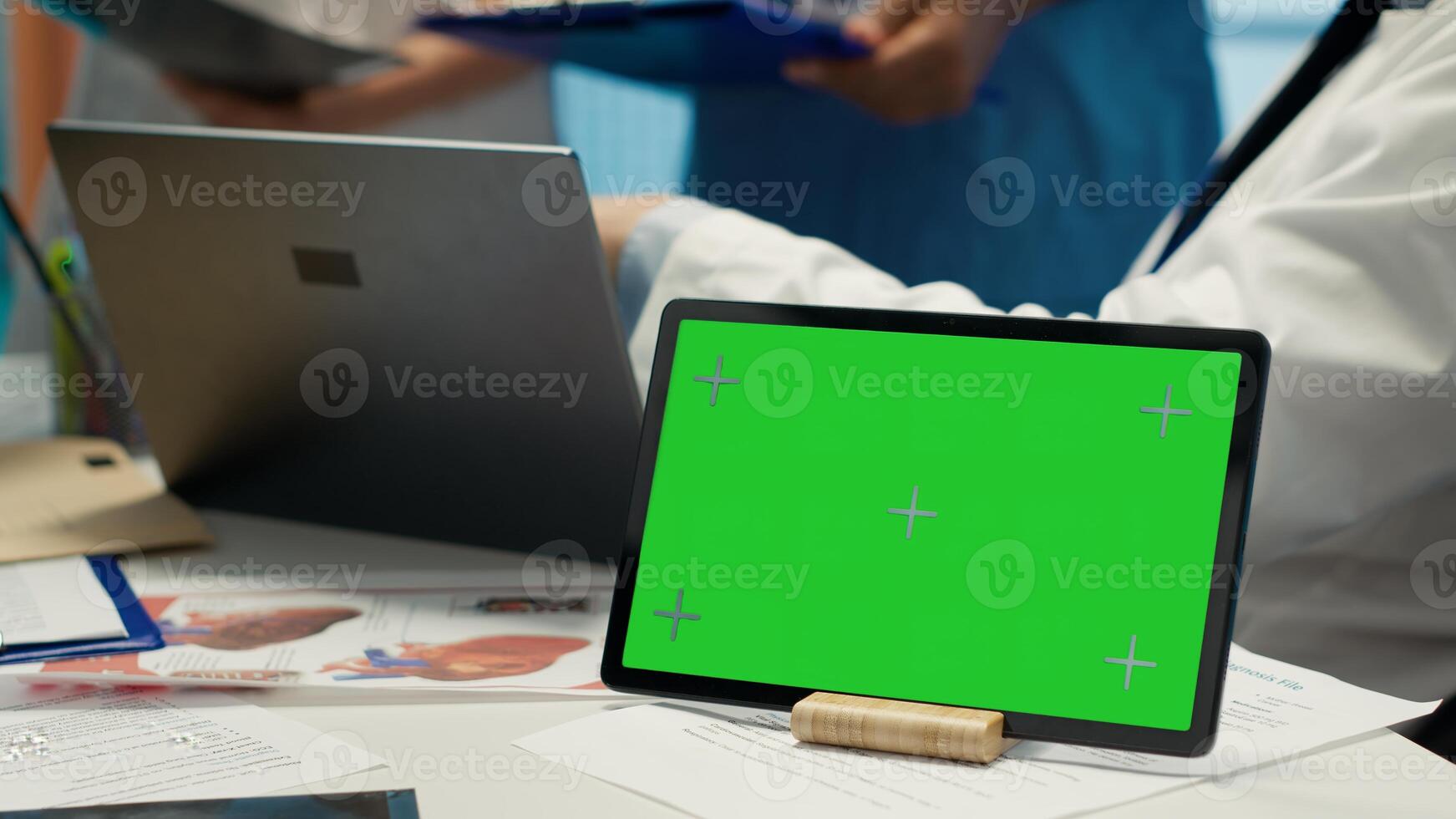 Licensed doctor and his staff review x ray scan results next to isolated copy space screen, examining hospital records before putting a diagnosis. Consulting analytics and radiography. Camera A. photo