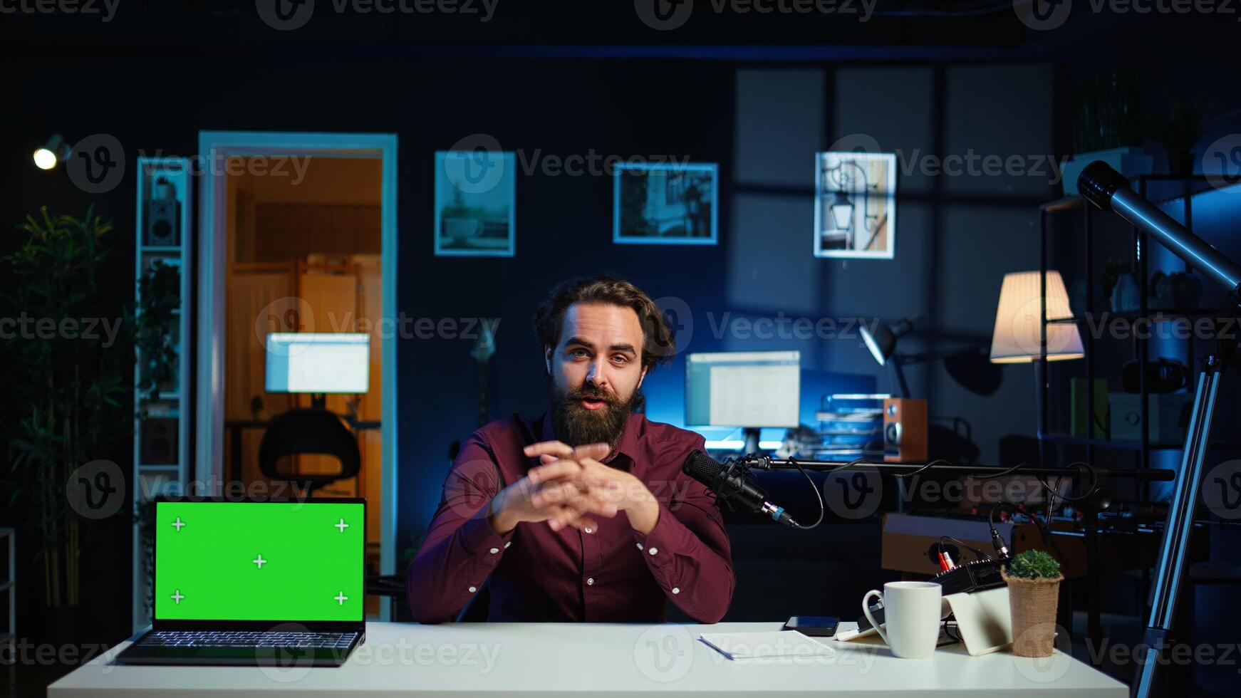 Tech guru in studio filming tech tutorial on how to do maintenance on chroma key laptop. Internet show host teaching viewers how to open and repair damaged green screen notebook, camera B photo