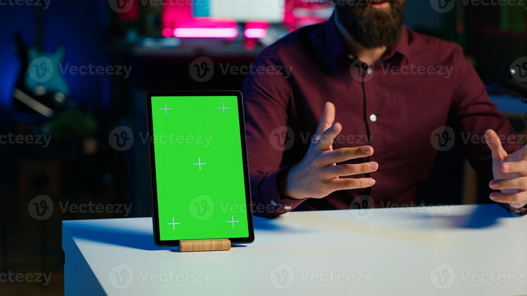 Happy influencer in studio filming chroma key tablet review for tech enthusiasts. Joyful media star hosts technology internet show, unboxing isolated screen digital portable device, camera A close up photo