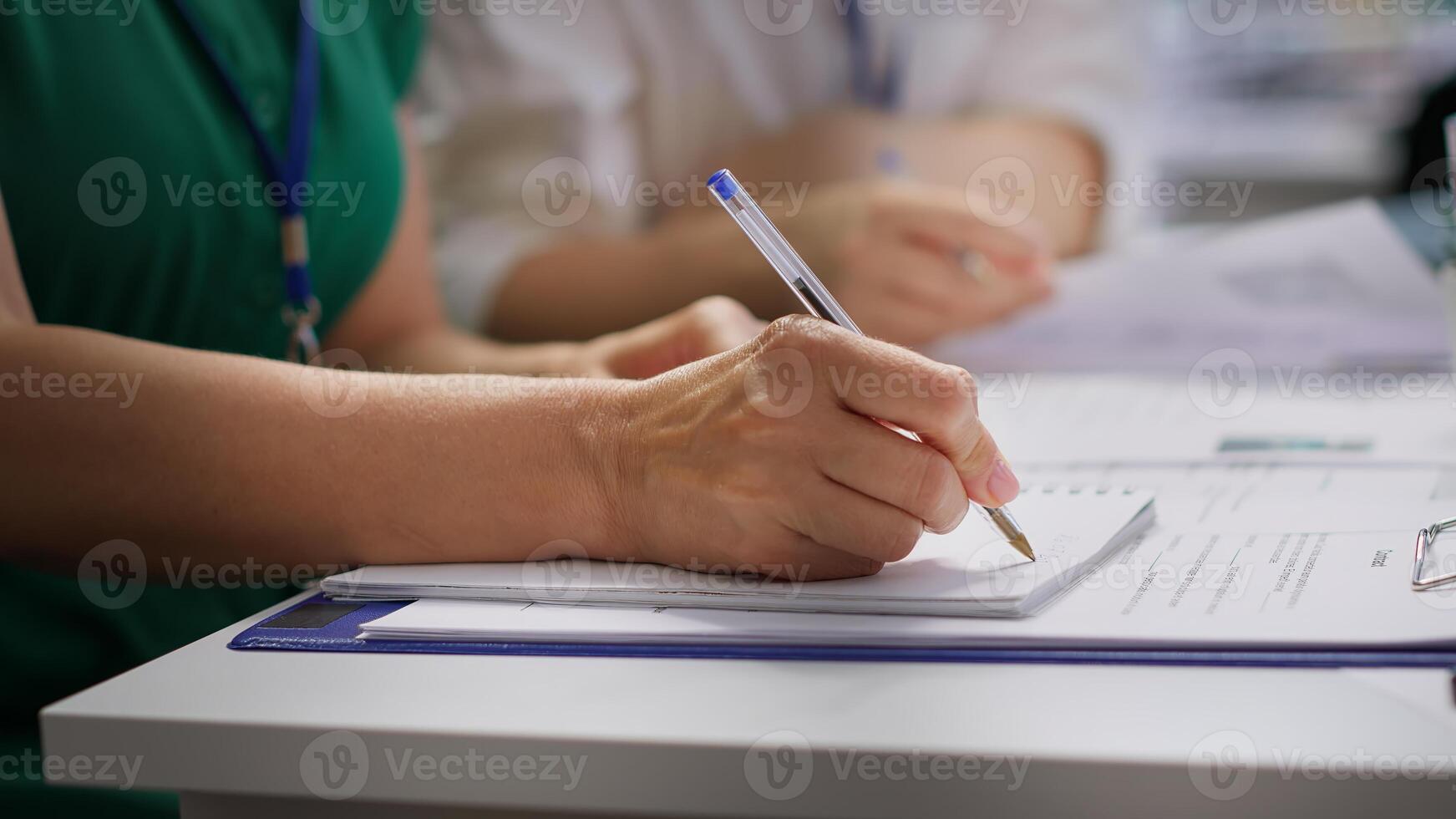HR recruiters interviewing a job seeker and taking notes during meeting, attending an interview and conducting an evaluation. Headhunters and applicant in recruitment process. Close up. Camera A. photo