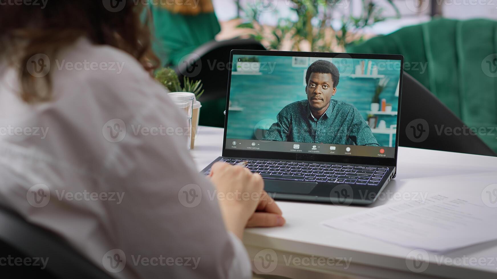 HR recruiter hosting an online interview with job applicant via internet teleconference call, evaluating candidate CV and discussing about career plans. Recruiting on remote videocall. Camera A. photo