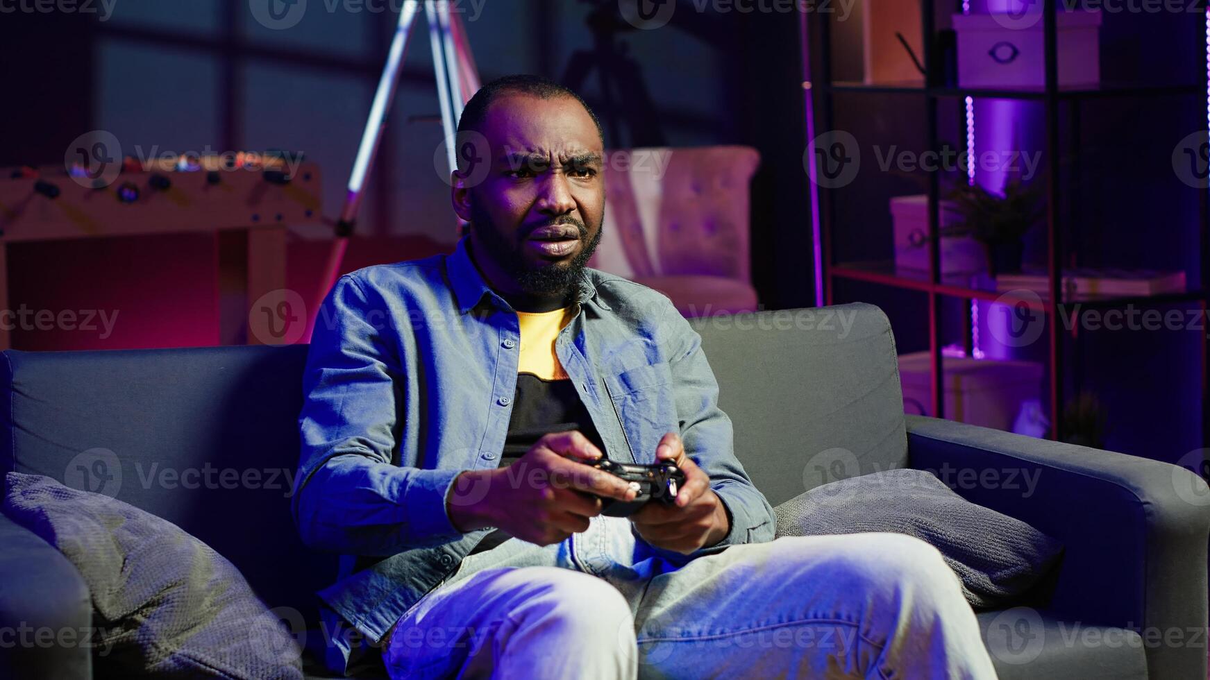 Irked gamer annoyed after losing in online singleplayer videogame played using controller. Man frustrated after failing to win game while playing on console with gamepad, camera A photo