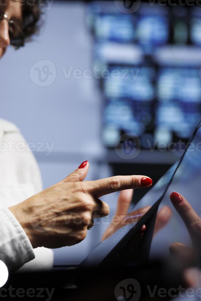 Competent engineers updating data center infrastructure, writing intricate binary code scripts on tablet, using programming to fortify cybersecurity in server farm, close up photo