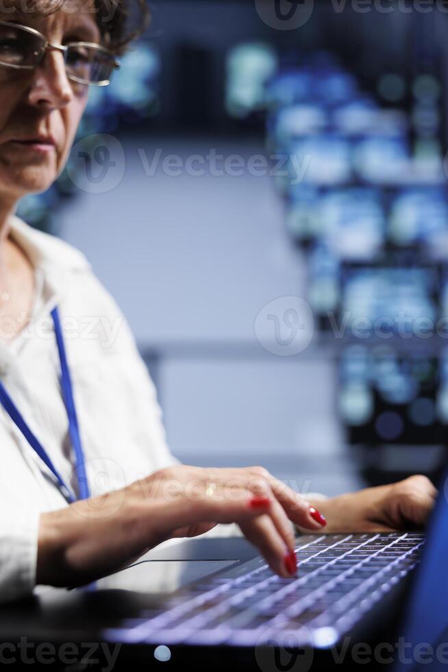 Skilled expert using laptop to make sure valuable data remains shielded from security issues, safeguarding high tech establishment servers against unauthorized access and vulnerabilities, close up photo