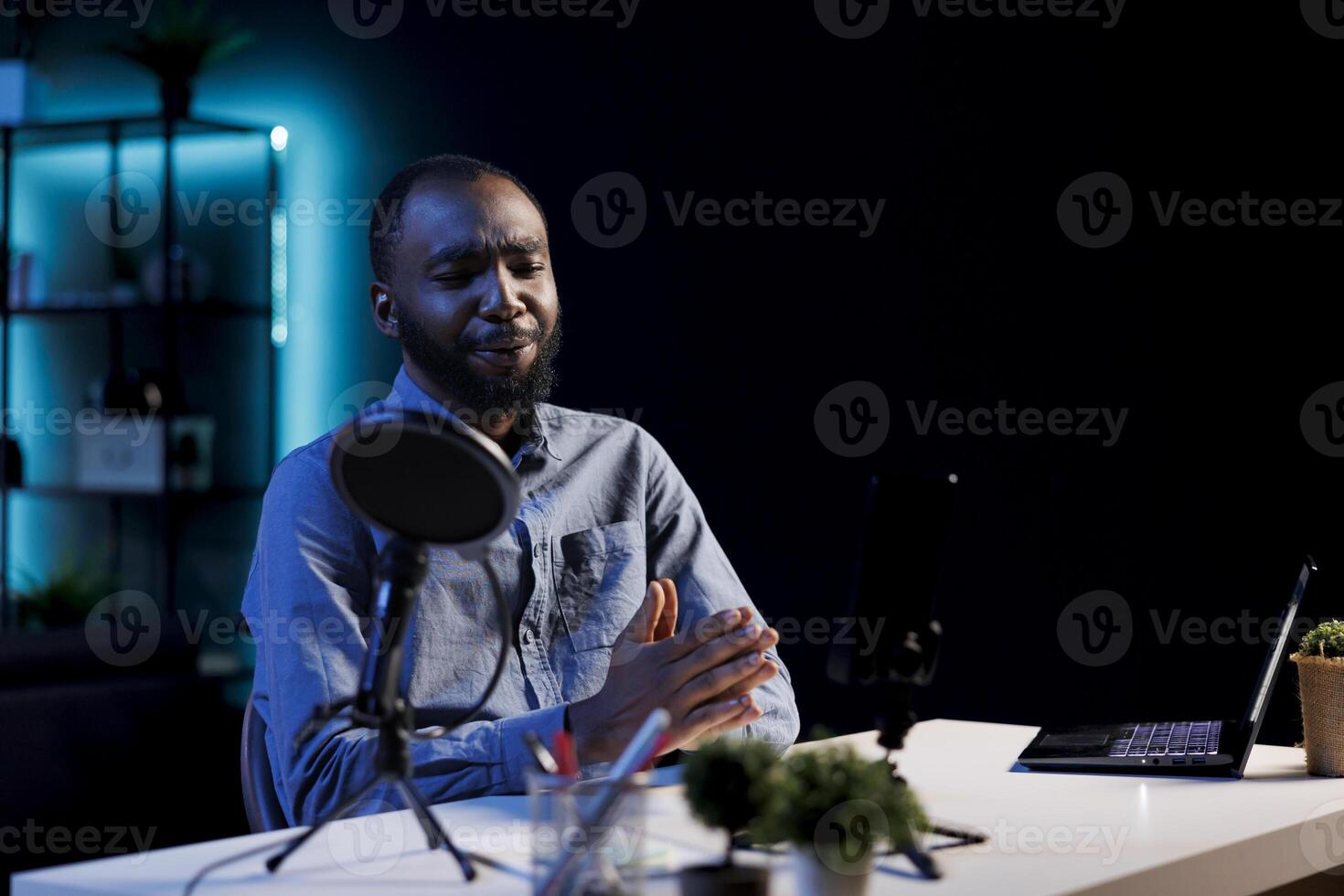 Entertainer using professional mic to record himself chatting with internet audience. Content creator discussing with viewers during live broadcast stream, using high quality audio equipment photo