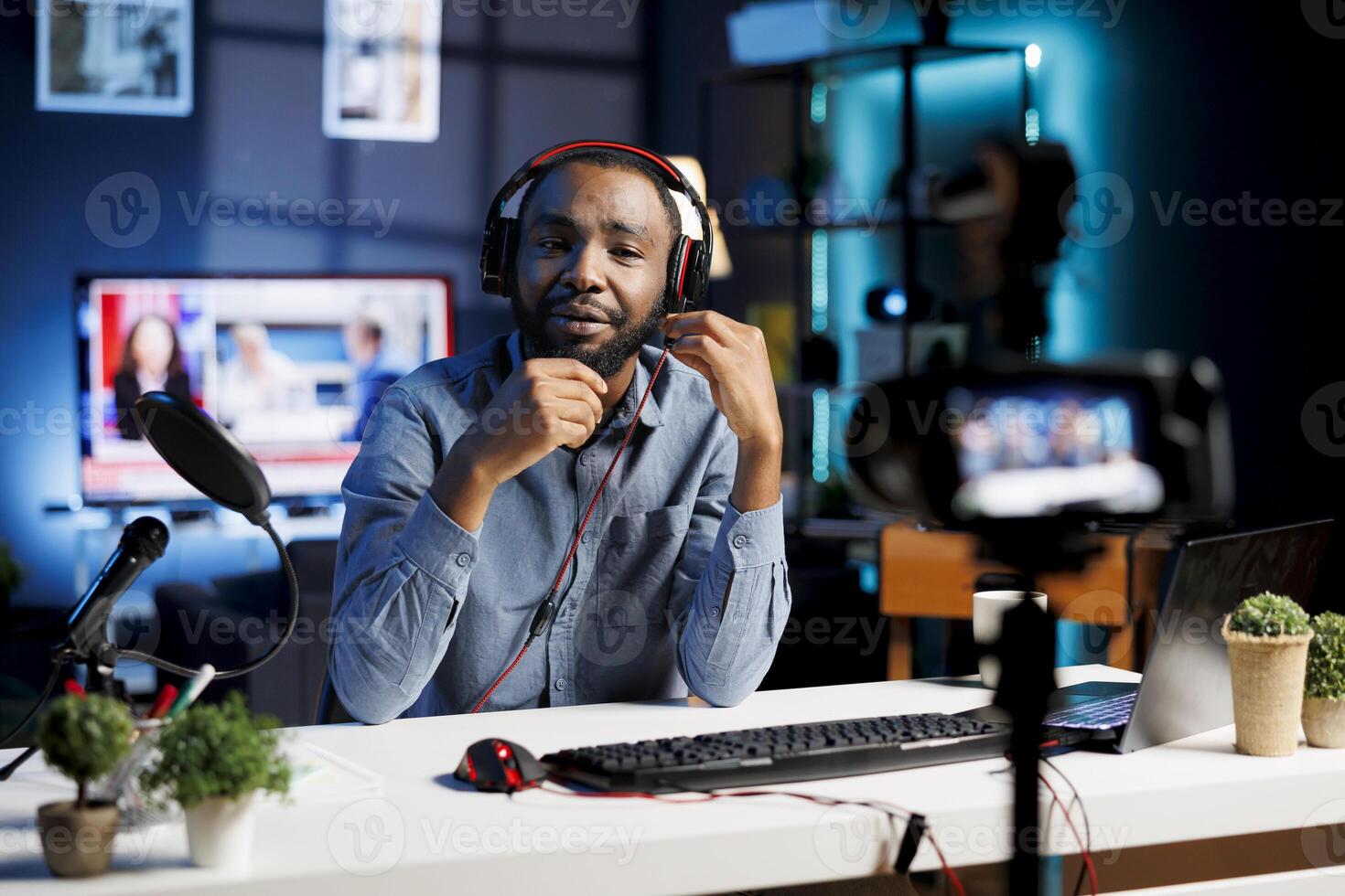 African American man assessing headphones, expressing dissatisfaction with subpar audio quality. Content creator shooting for online channel, displeased with audio device performance photo