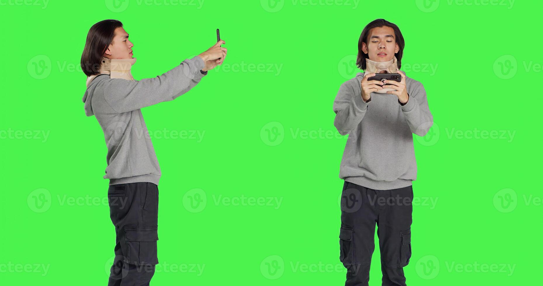 Wounded guy wearing cervical collar on videocall across greenscreen, engaging on remote internet discussion while wearing medical neck support after injury. Man suffered vertebral lesion. photo