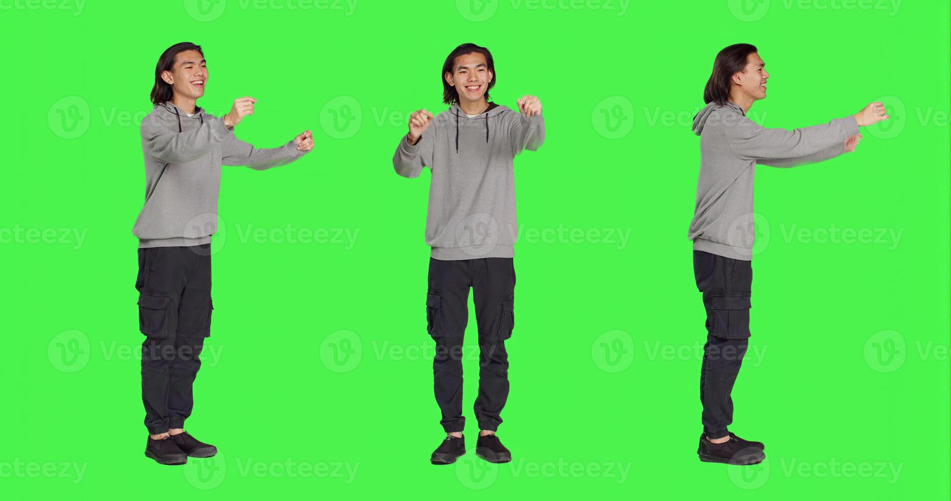 Asian man acting as choir director for musical show, moving hands like a choirmaster chief over greenscreen backdrop. Male person conducting band to sing, smiling choirmaster musician. photo