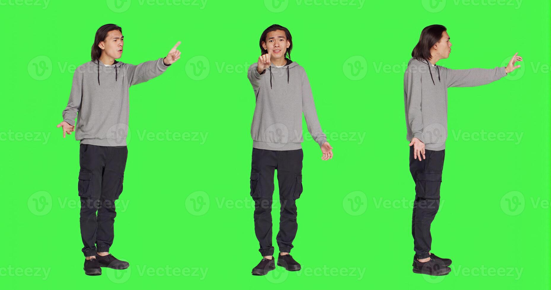 Young adult showing no symbol in studio, expressing negativity and disagreement over isolated greenscreen backdrop. Asian male person being disappointed and disapproving with something. photo