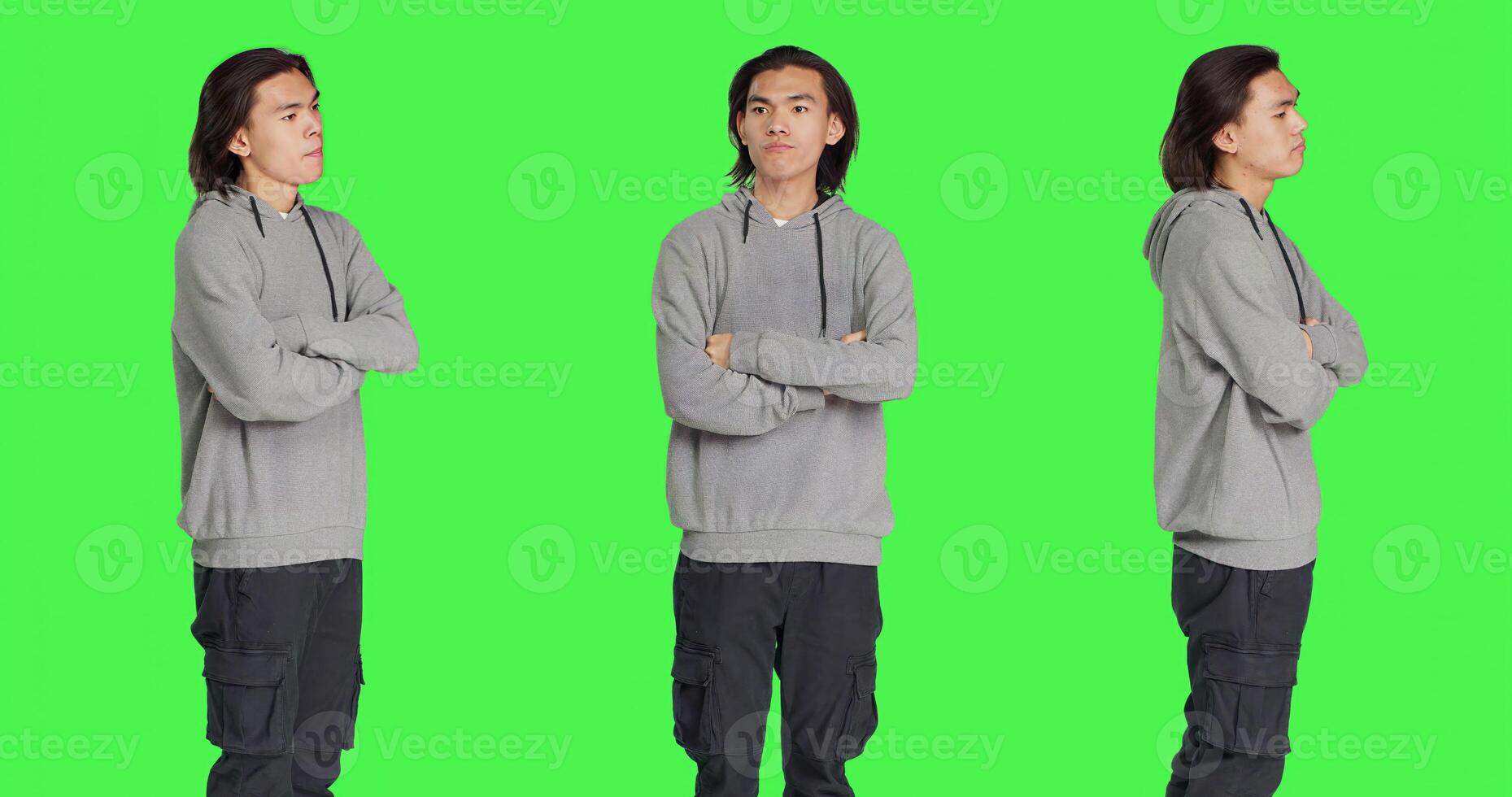 Impatient person waiting for something in studio, looking around and checking time on wristwatch over greenscreen background. Asian man being grumpy and snappy, looks at watch. photo