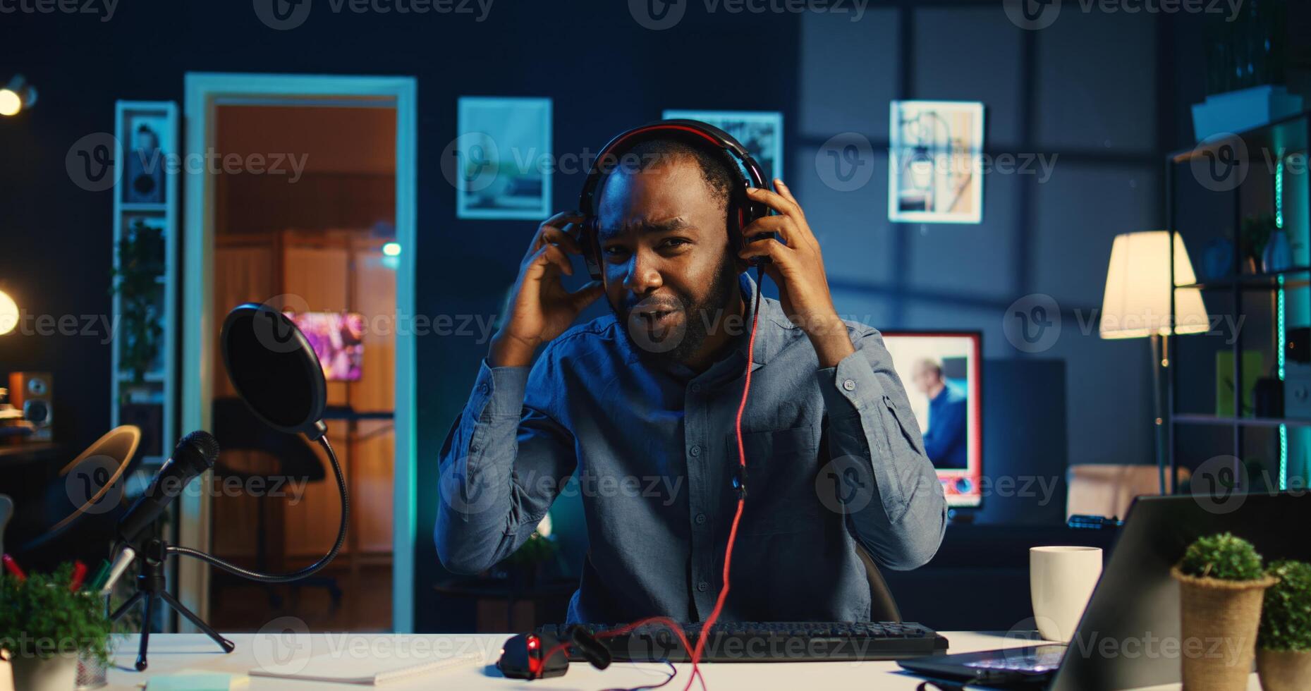 African american technology internet star filming review of newly released wired gaming peripherals, giving audience feedback about them and presenting specifications, doing endorsement photo