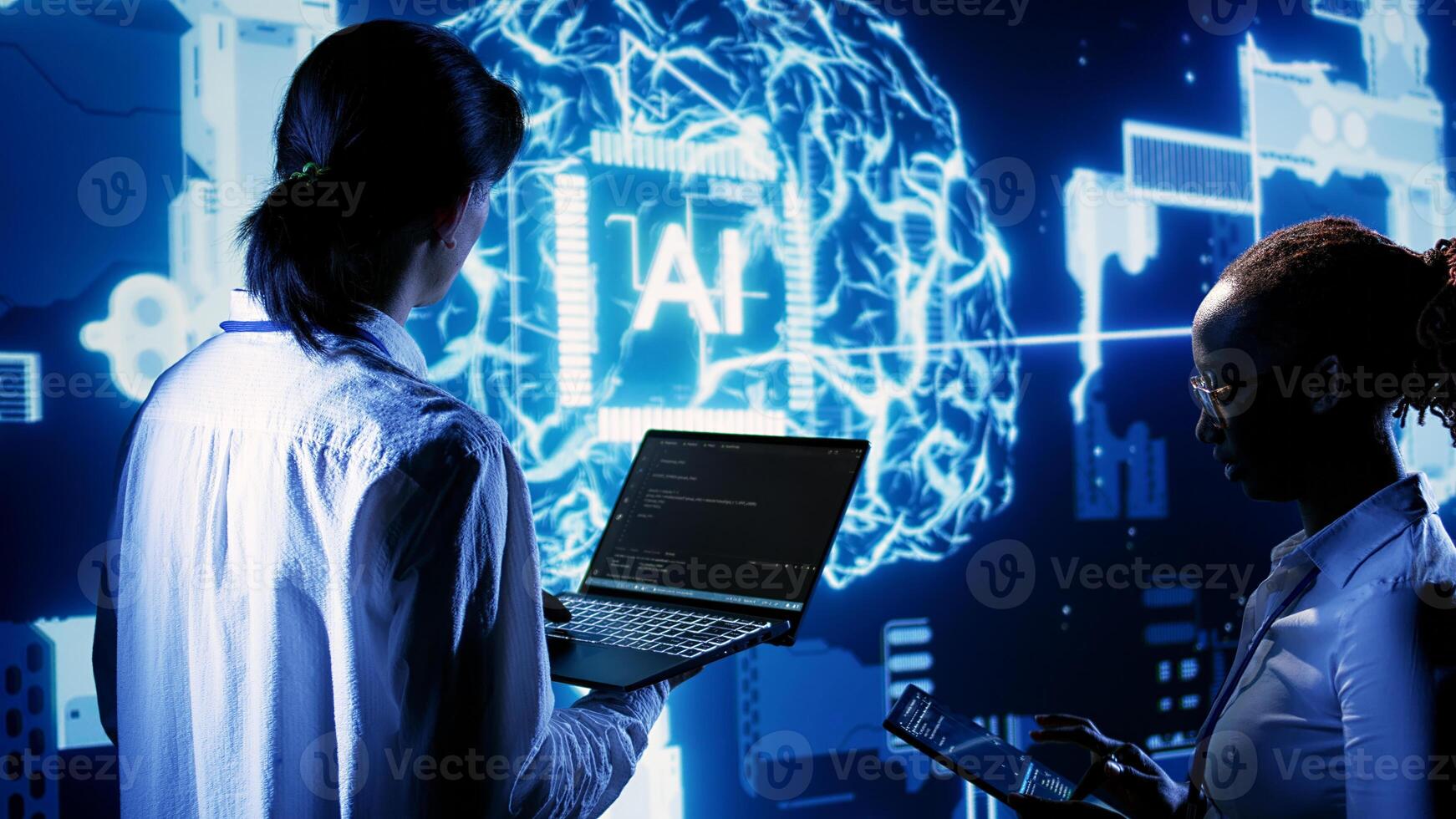 IT team members programming scripts on laptop, employing AI machine learning. African american developer and asian coworker manipulating lines of code for artificial intelligence applications photo