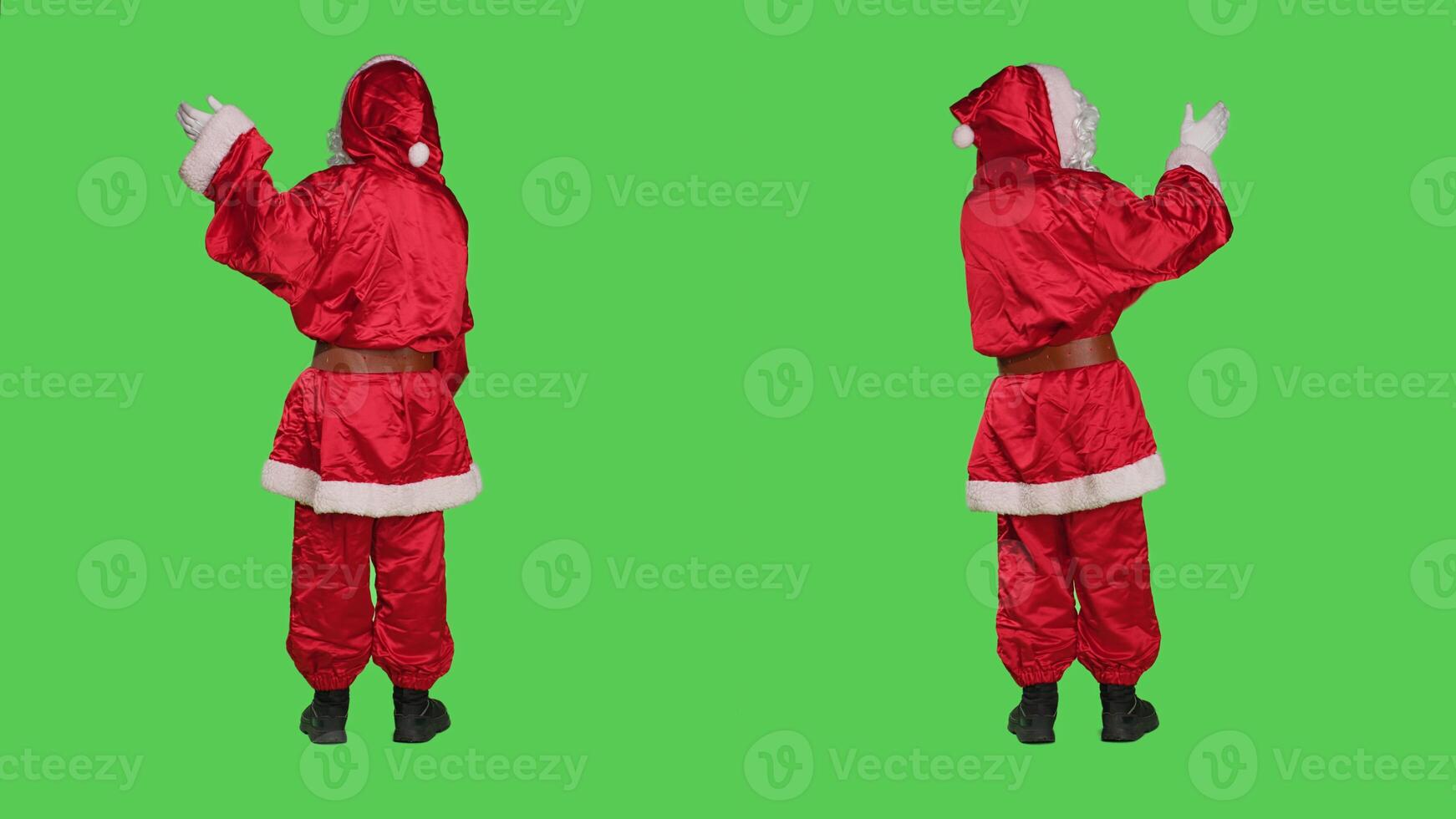Saint nick doing marketing ad during christmas holiday season, create advertisement over full body greenscreen backdrop. Santa in costume pointing to both sides in studio, december event. photo