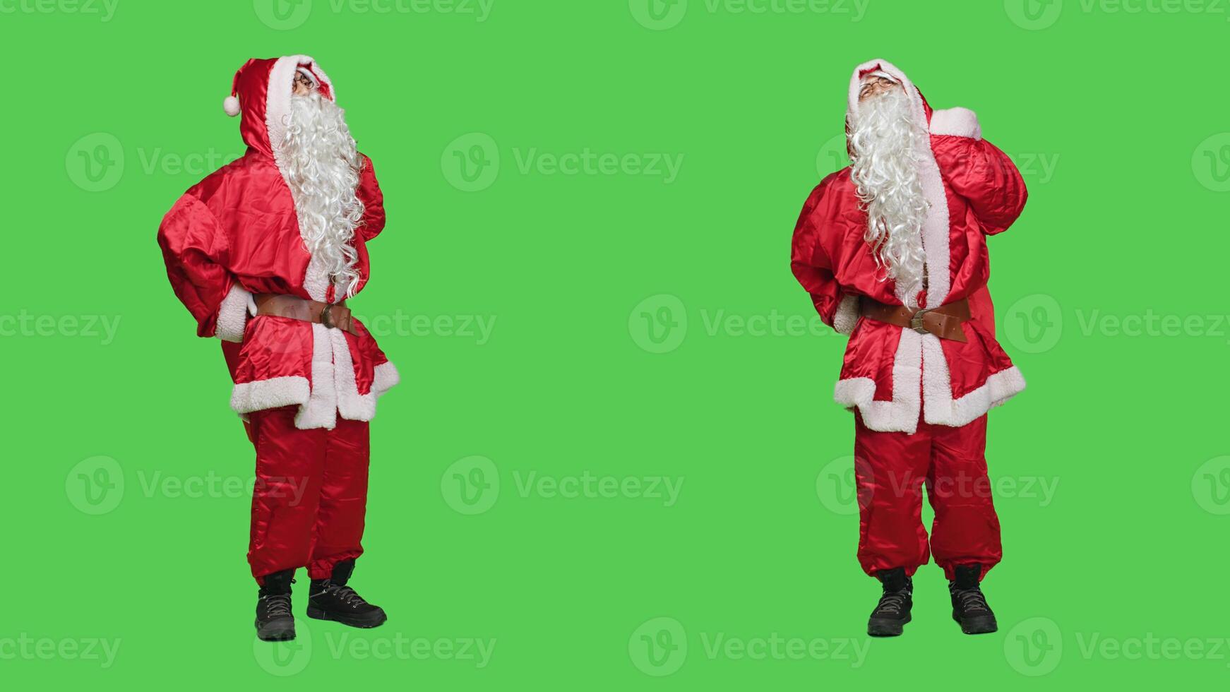 Saint nick cosplay deals with backpain, feeling sick and trying to carry bag filled with presents. Santa claus character being unwell and hurt in red seasonal suit, full body greenscreen backdrop. photo
