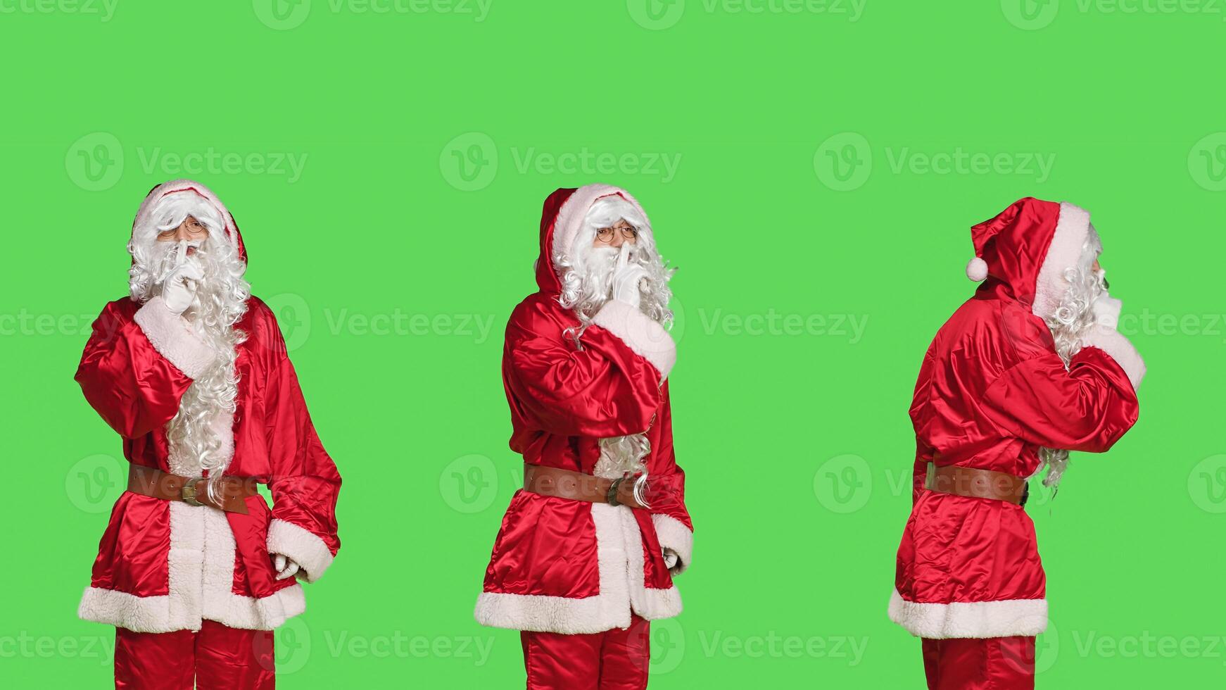 Discreet saint nick does hush sign in studio, expressing secrecy with confidential symbol on greenscreen backdrop. Santa claus man in suit showing mute gesture, silence concept. photo